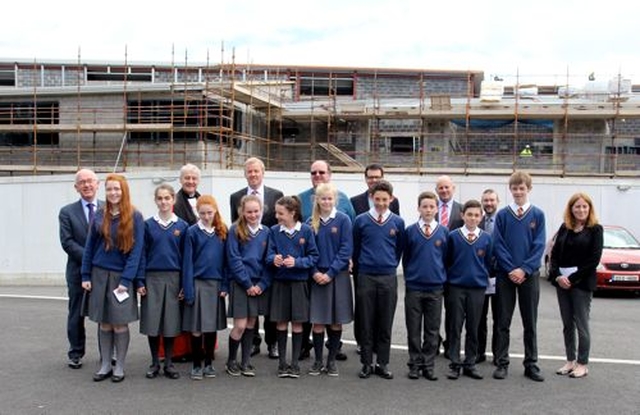 Garrett Fennell, Archbishop Michael Jackson, Tony Goodwin, the Revd Baden Stanley, the Revd David Mungavin, Principal Alan Cox, Dr Ken Fennelly and Deputy Principal Niamh McShane with some Temple Carrig School students in front of their new school building in Greystones following the service marking the end of the school’s first academic year. 
