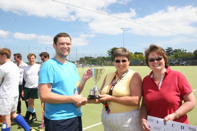 Bray Captain Simon O'Connor receives the Archbishop's Cup for his team winning the Diocesan Inter-Parish Hockey Tournament. Presenting the trophy is the Revd Gillian Wharton and fellow organiser of the competition, the Revd Anne Taylor.