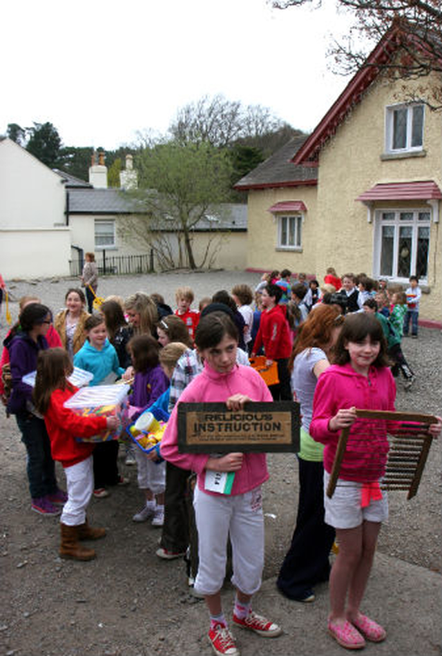 The pupils from Powerscourt National School lined up and prepared to leave the old schoolhouse in Enniskerry for the last time. The schoolhouse had been in continuous use since 1918 and the children carried items from their old school to the new building – which is one of only two passive schools in the country. 