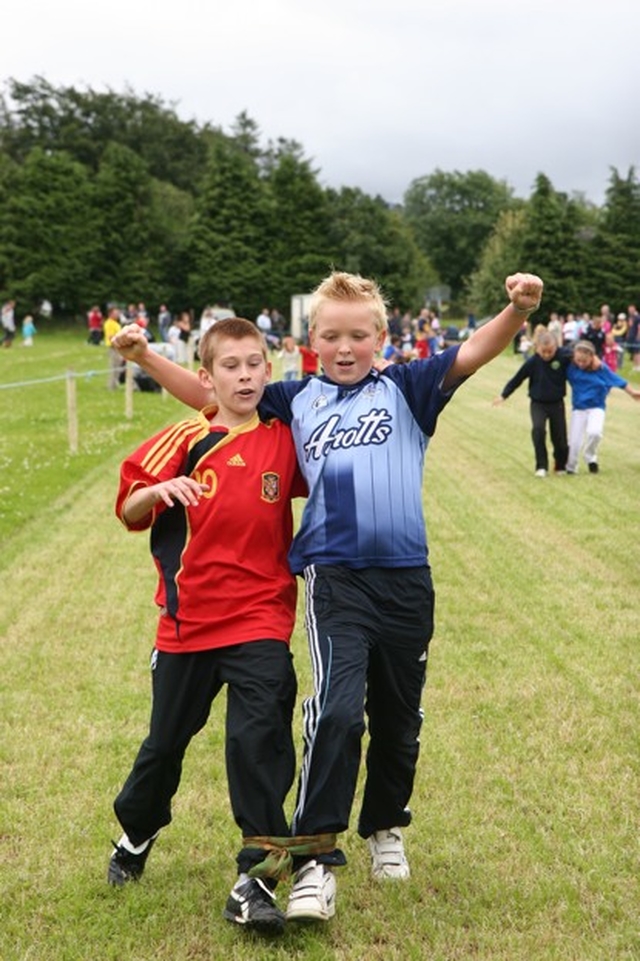 A Dublin and Spanish Combo win the Three legged race at a parish Fete in County Wicklow.
