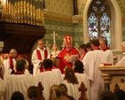 The Archbishop of Dublin, the Most Revd Dr John Neill presents the Revd Suzanne Harris with a bible at her ordination to the priesthood in St Philips and St James' Church, Booterstown.