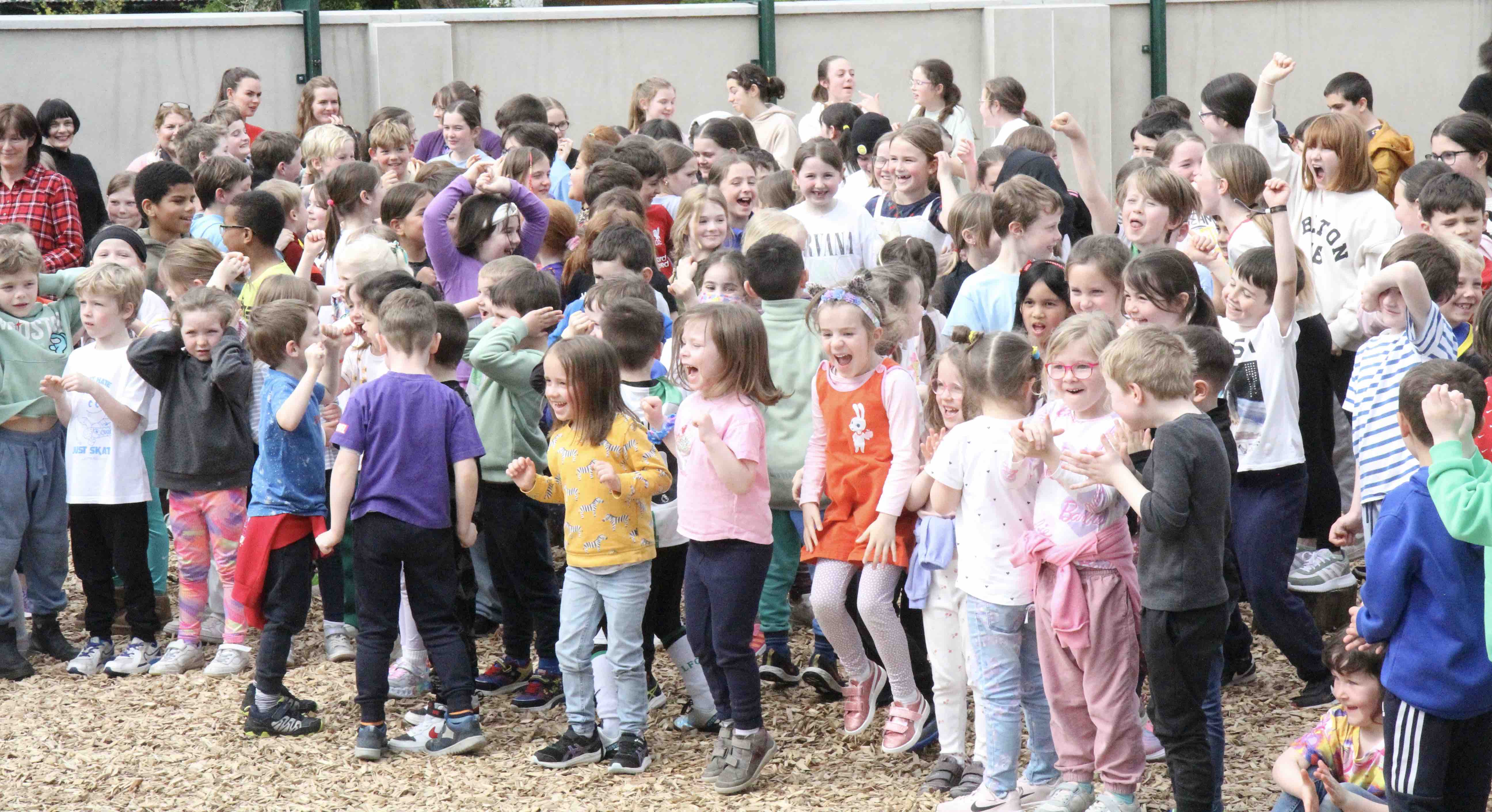 Pupils celebrate the opening of their new play area.