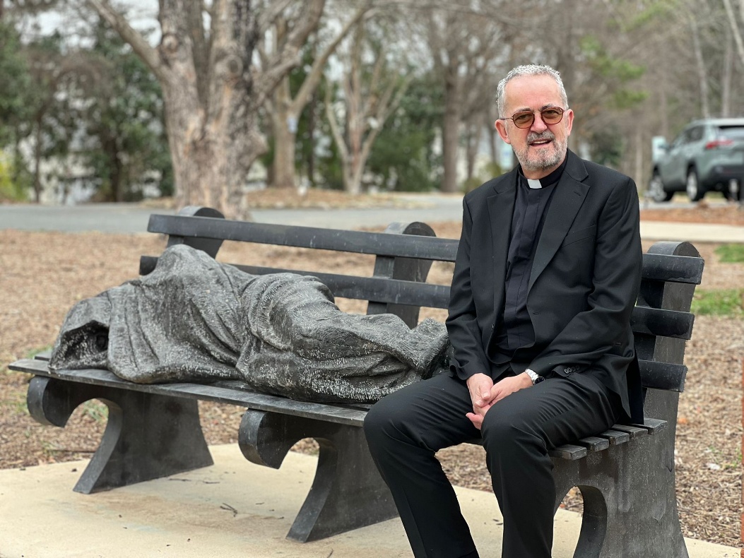 The Dean alongside Davidson's Homeless Jesus.