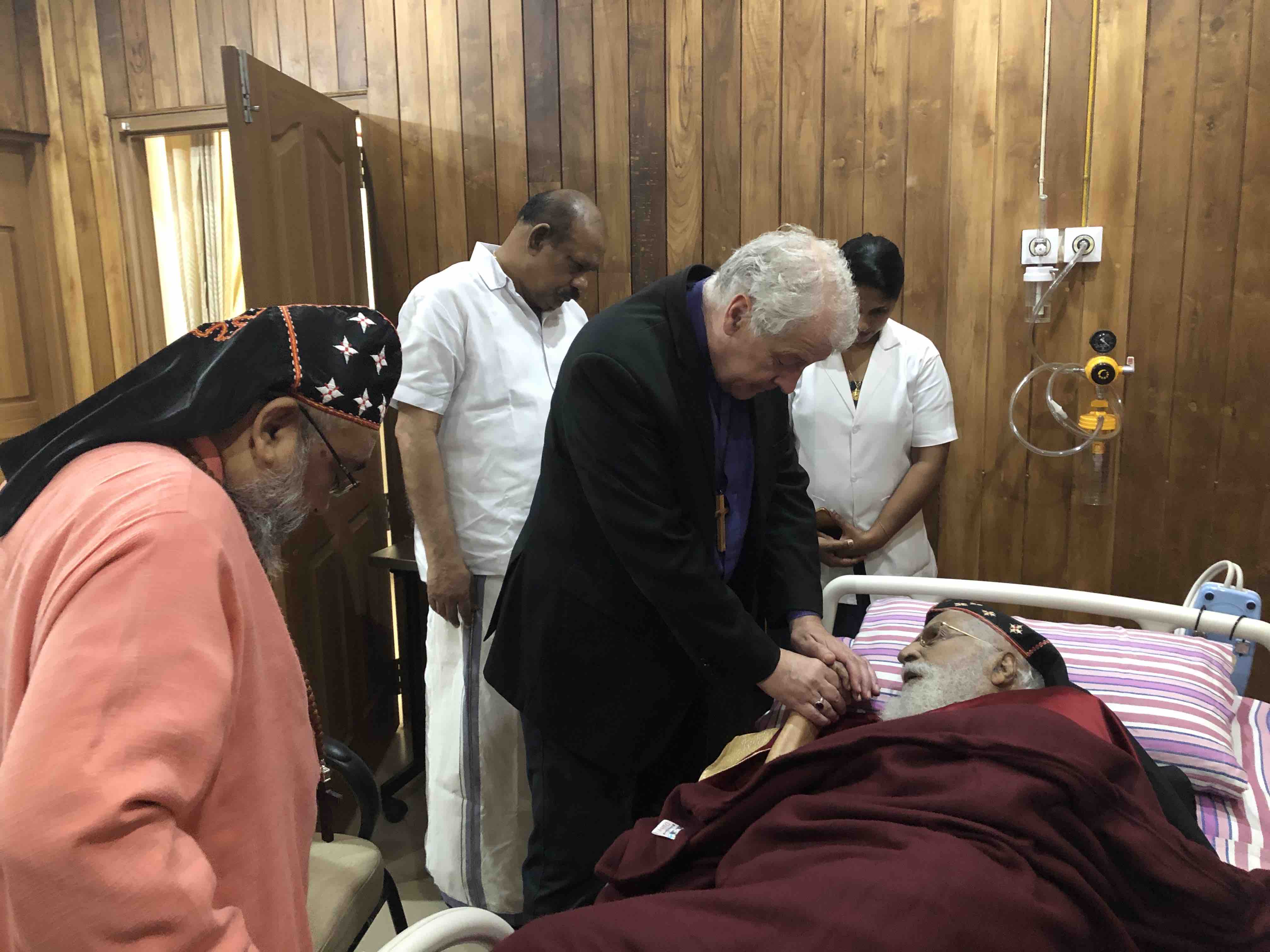 Archbishop Jackson praying with the Metropolitan Emeritus (aged 102) in hospital.