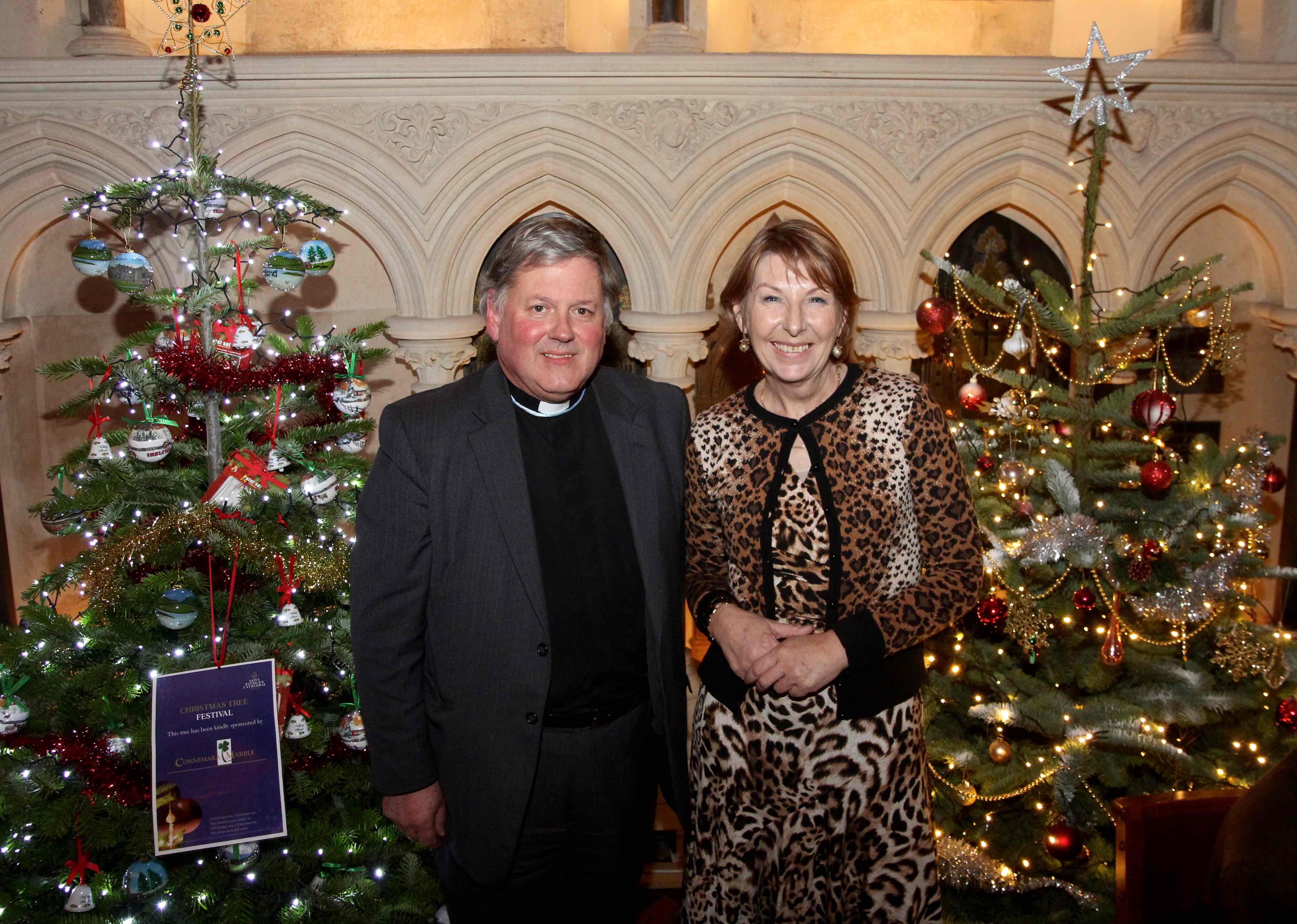 Dean William Morton and Áine Lawlor among the trees at St Patrick's Cathedral's Christmas Tree Festival