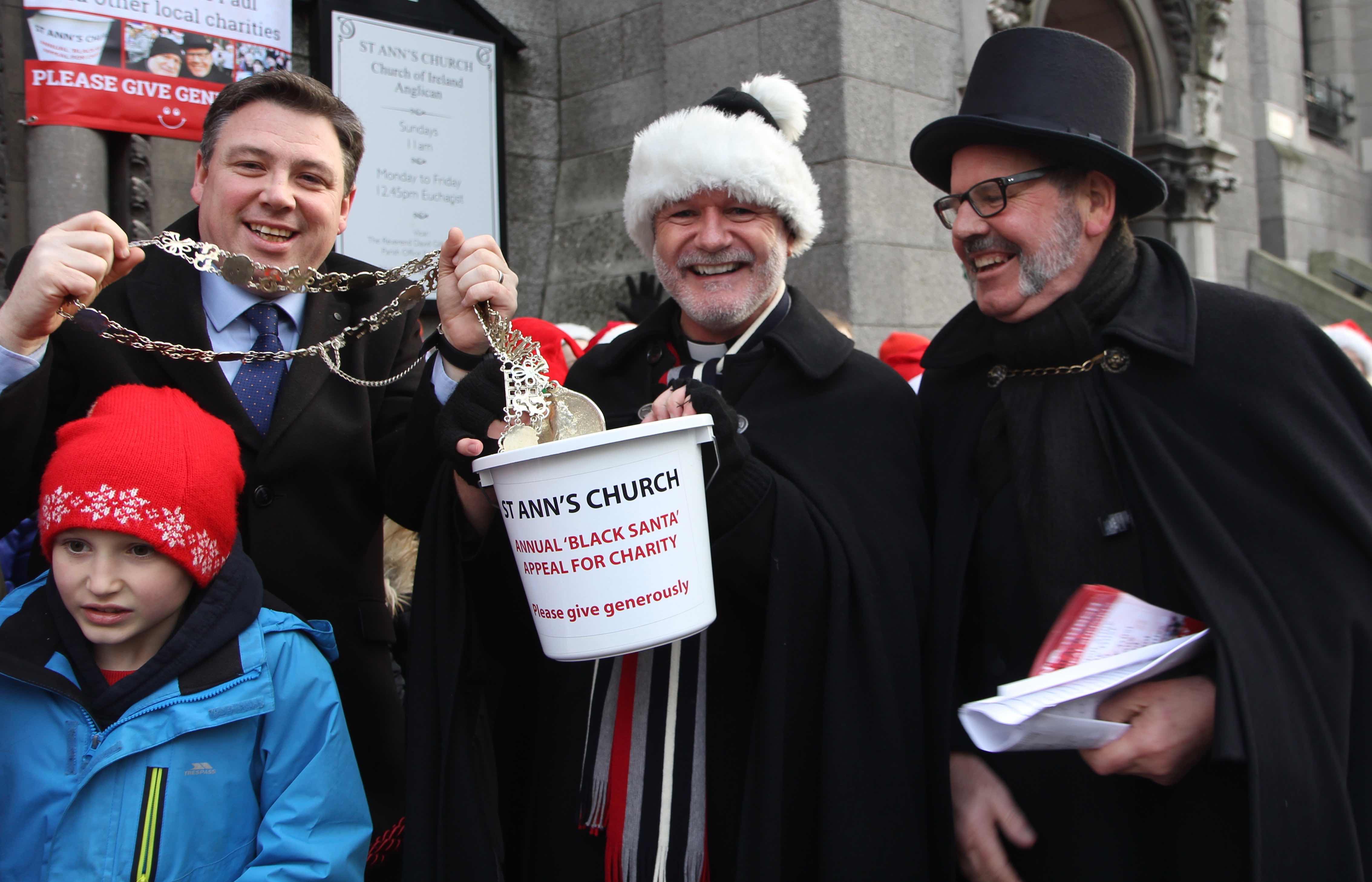 Lord Mayor Paul McAuliffe makes a generous donation to the Black Santa Appeal with Canon David Gillespie and Fred Deane.