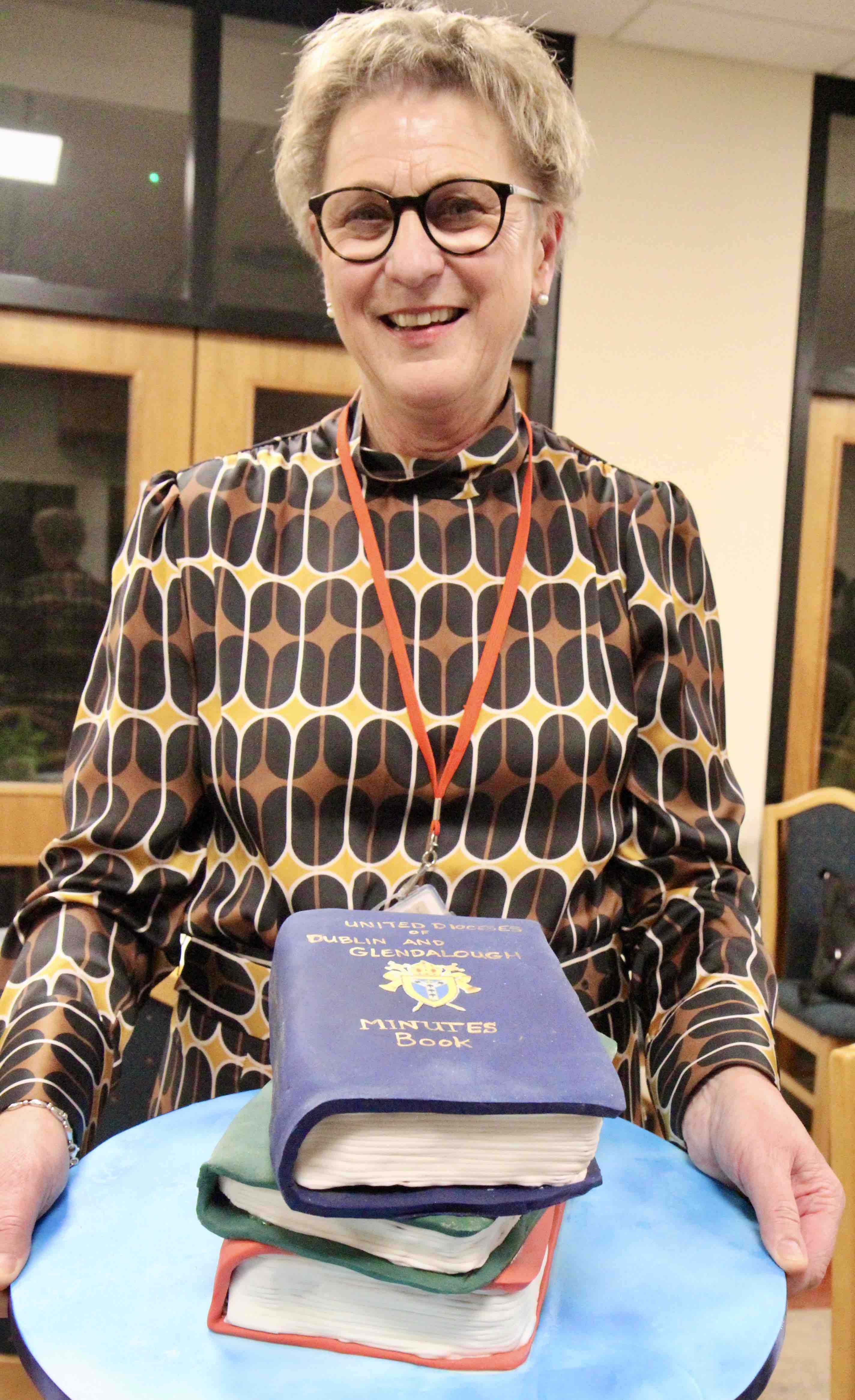 Sylvia Heggie and the cake representing her years of service to the dioceses.