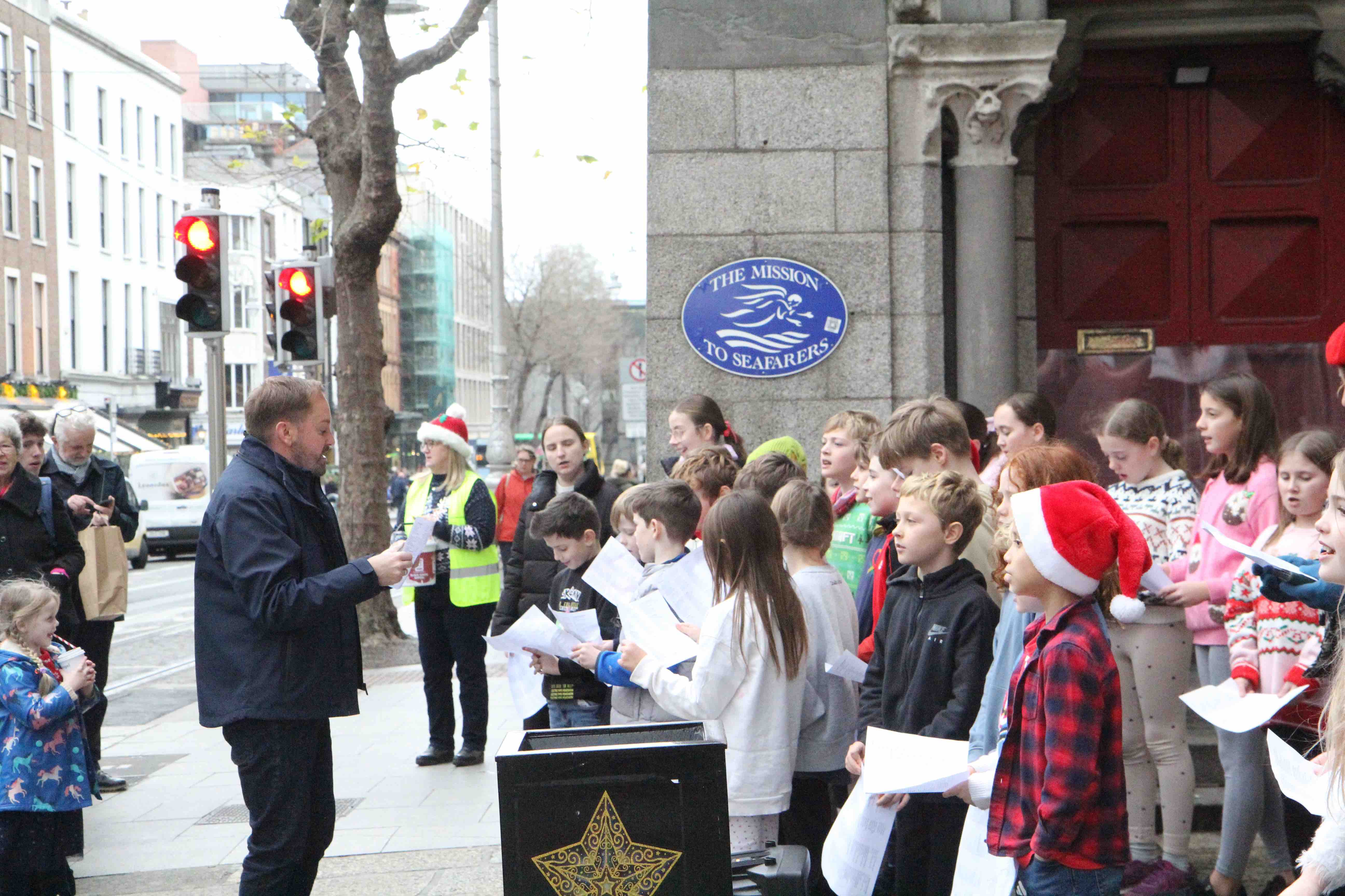 Kildare Place School principal Ian Packham conducts the school choir.