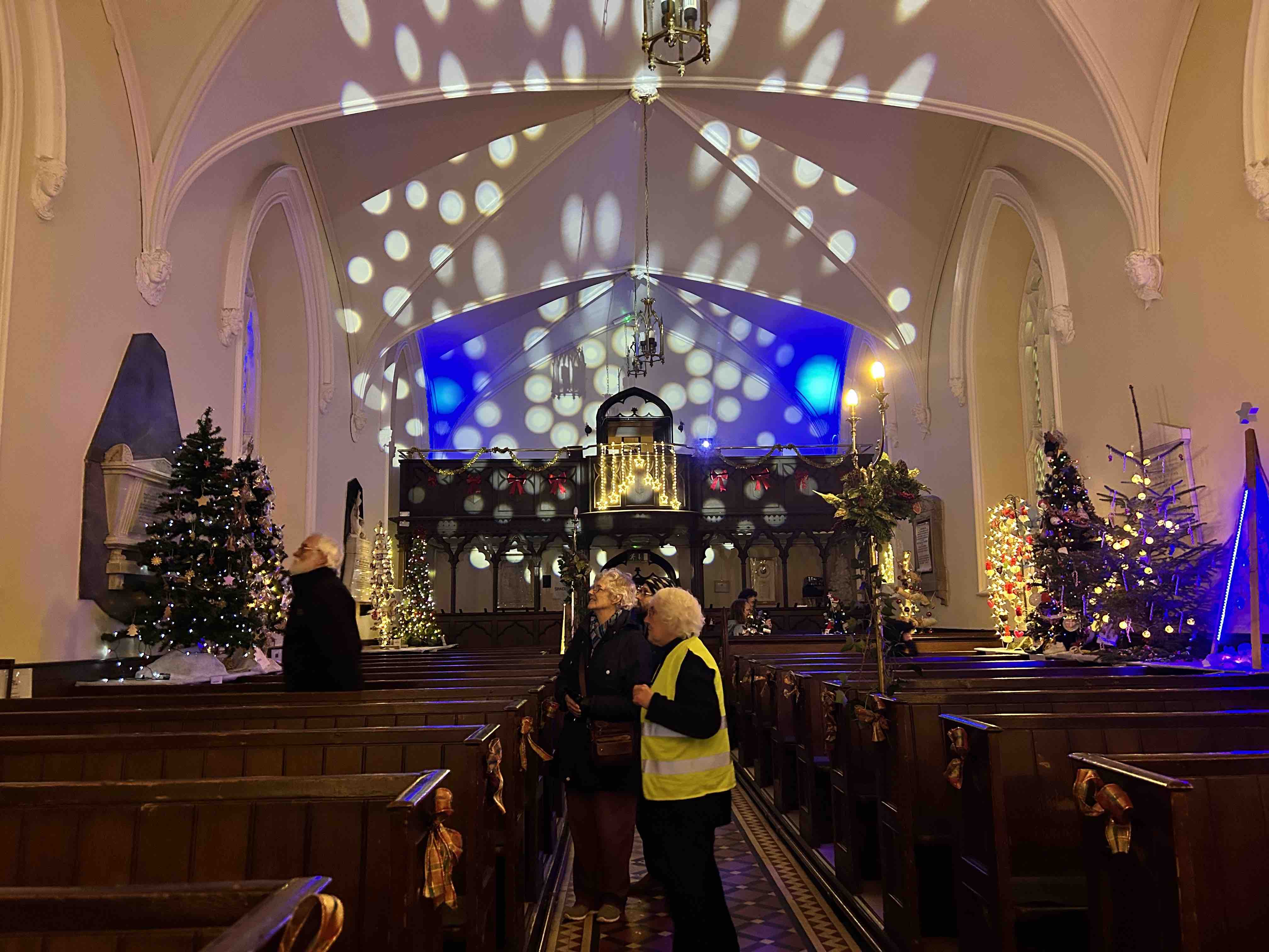 Juliette Belton shows visitors around the Nun's Cross Christmas Tree Festival.