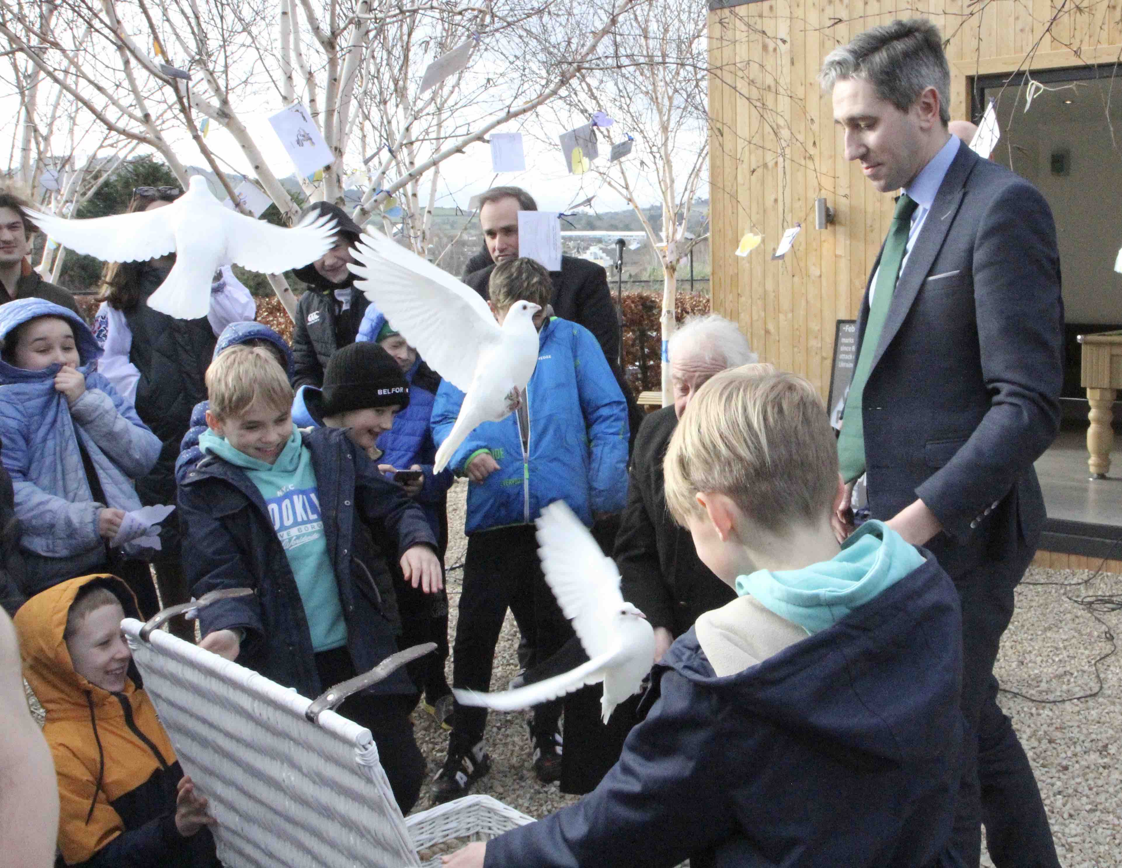 Children from Ukraine, assisted by Archbishop Micheal Jackson and Minister Simon Harris, release doves as a symbol of their wish for peace.