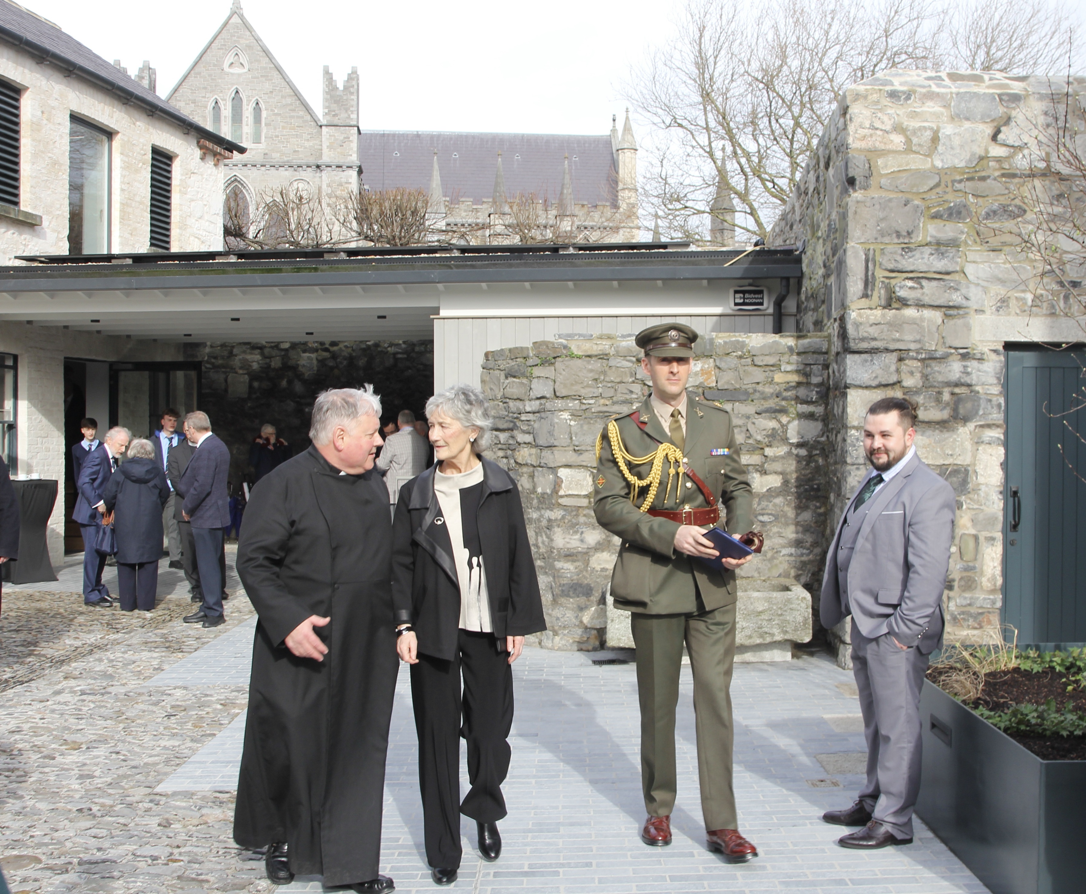 President Catherine Connolly and Dean William Morton in the grounds of the deanery with The Mews in the background.