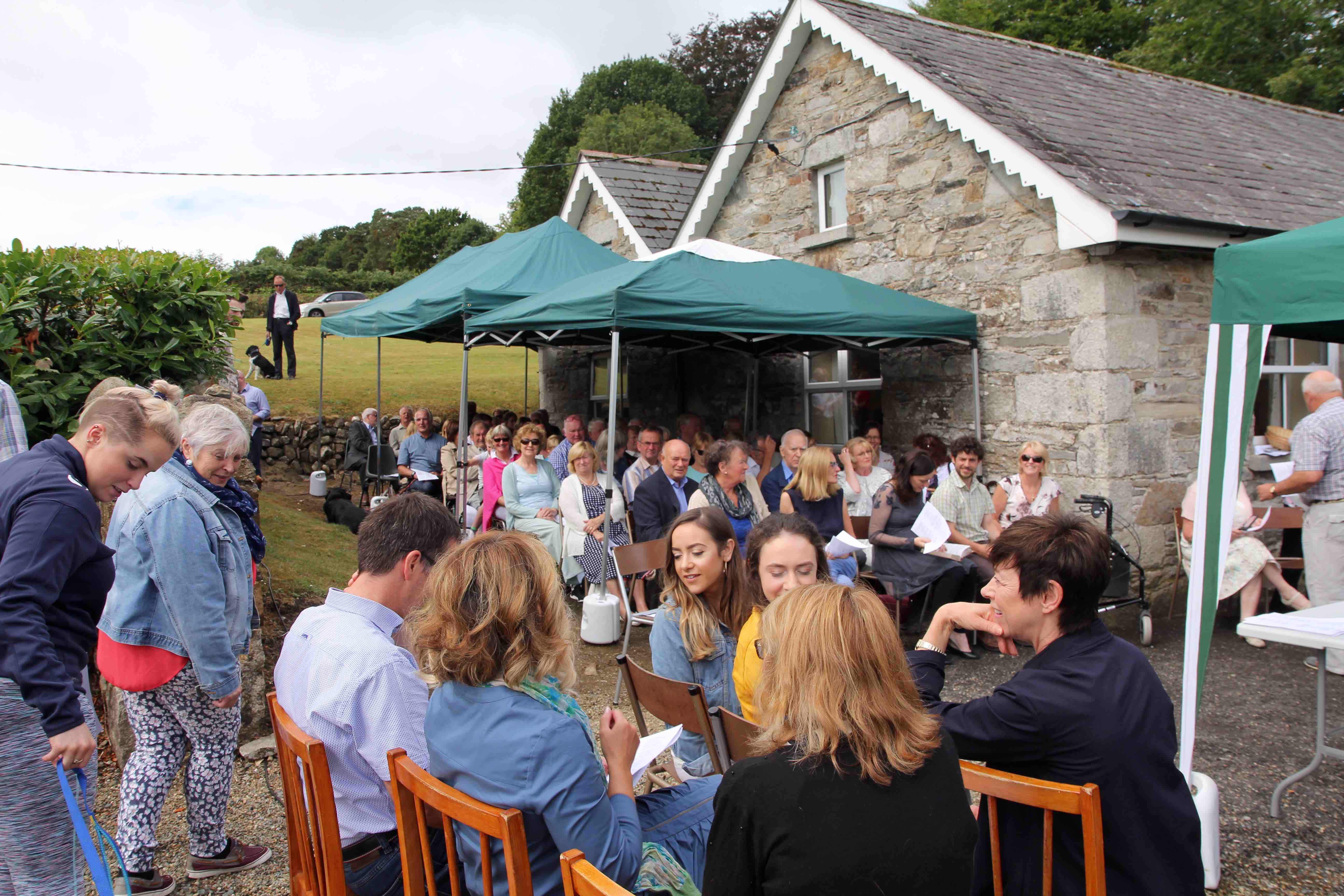 Parishioners and their dogs gather for Canon George Butler's last service in Ballinatone Church.