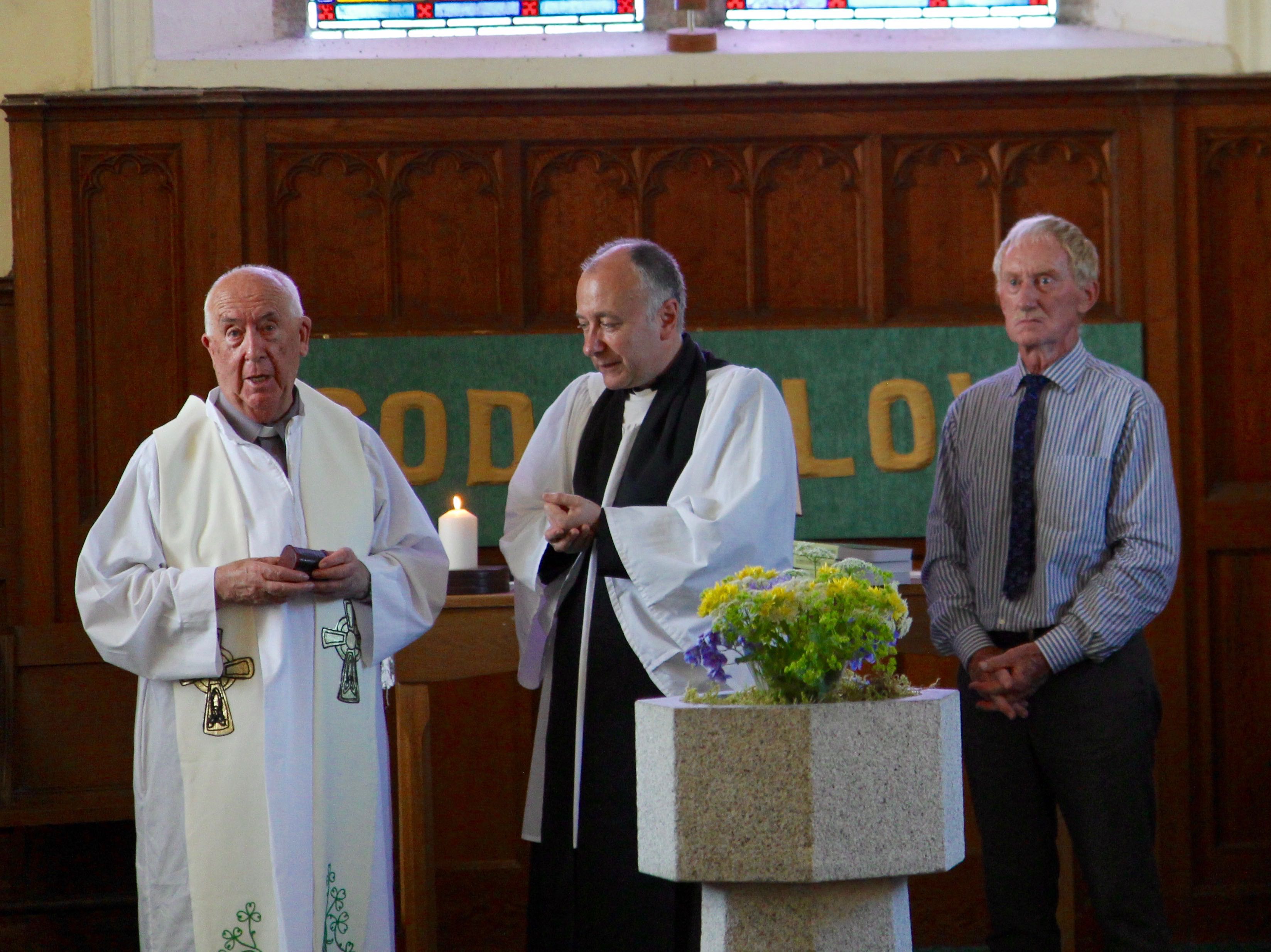 Fr James Prendiville presents a key to Hollywood Church to the Revd Leonard Ruddock.