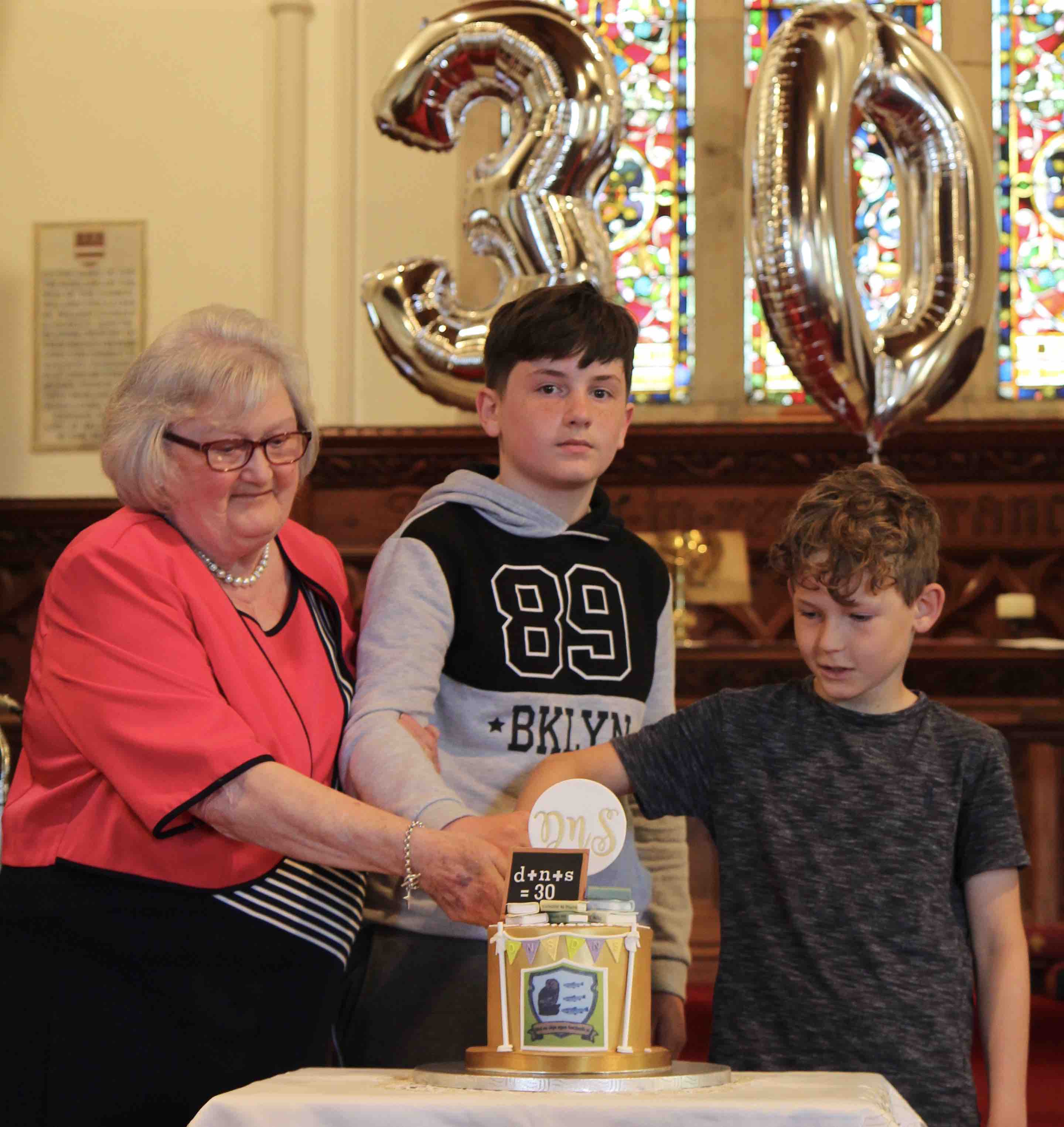 Former principal Sally Watson and her grandchildren.