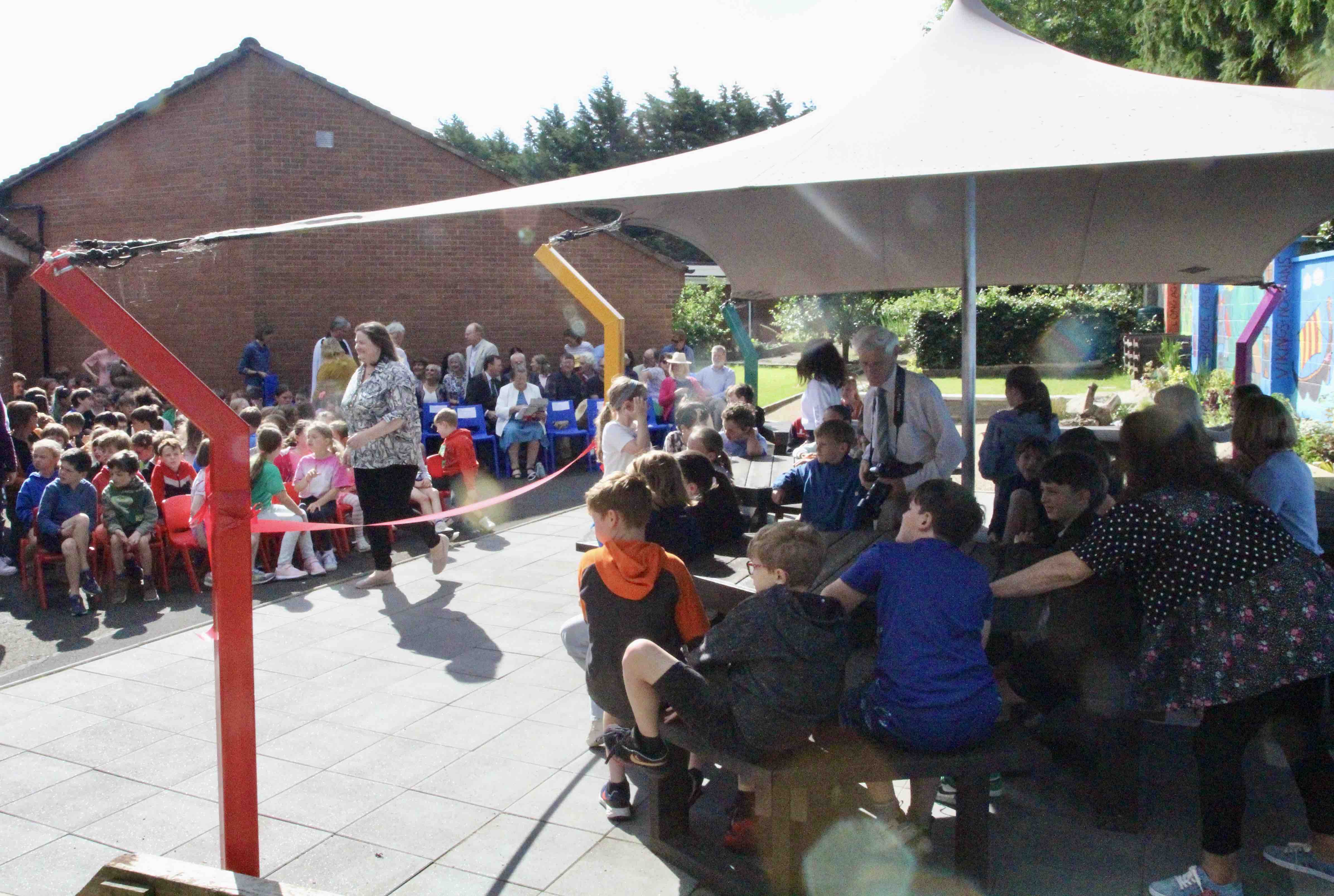 Pupils gather in the new outdoor classroom and the yard for the official opening.