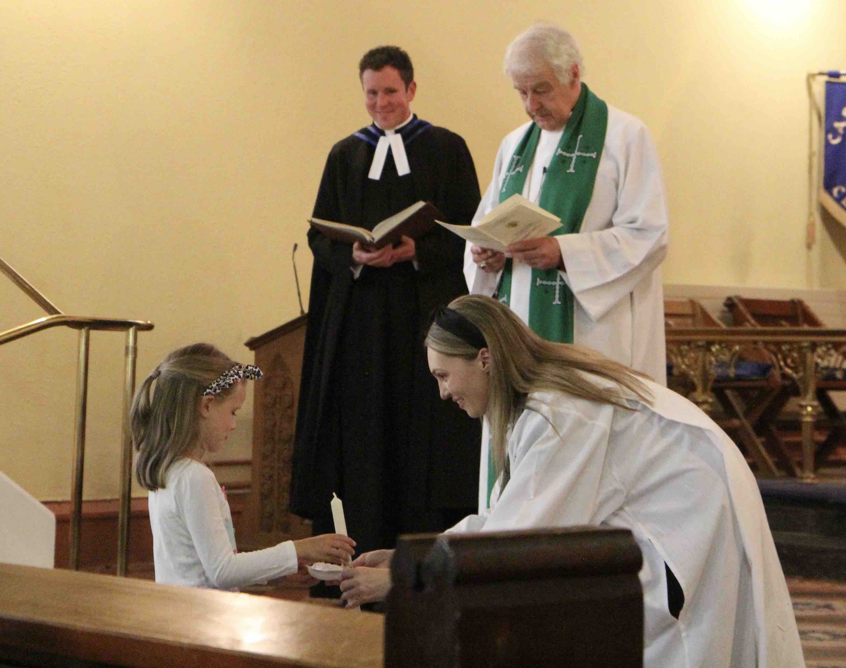 Natasha receives one of the symbols of her ministry from a young parishioner.