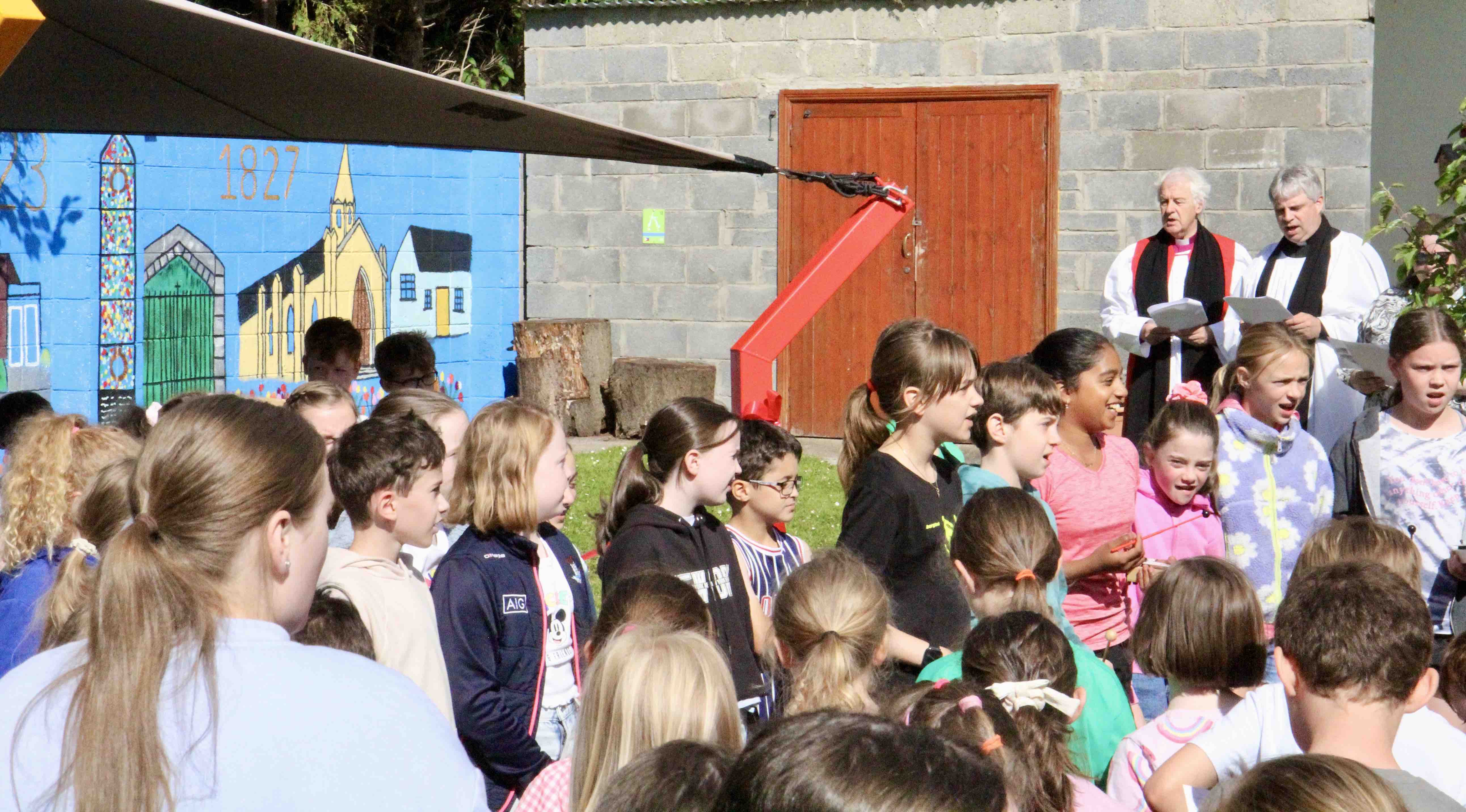 Whitechurch School Choir leads the singing.