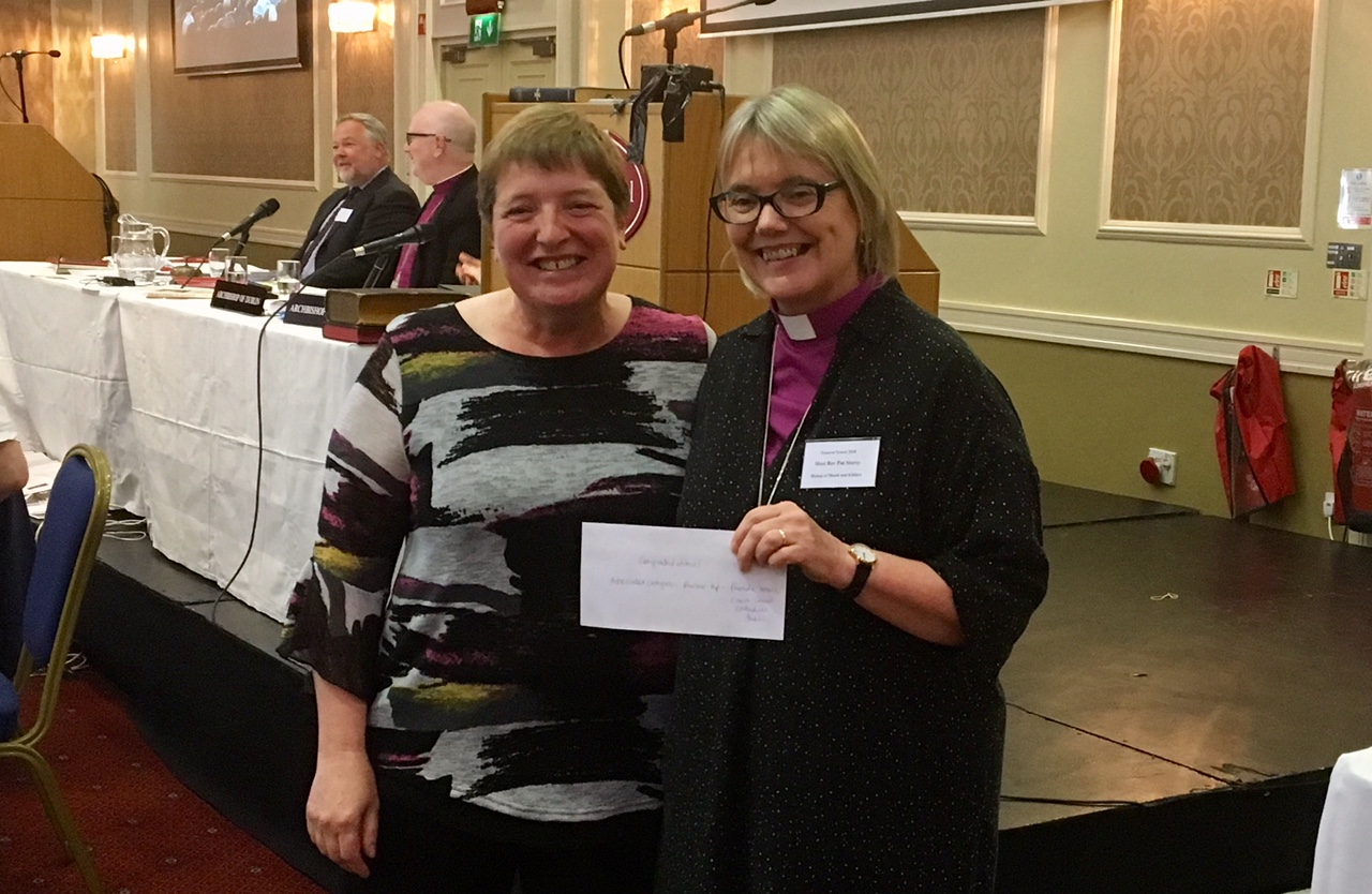 Leslie Rue receiving her prize from Bishop Pat Storey in the Communications Competition.