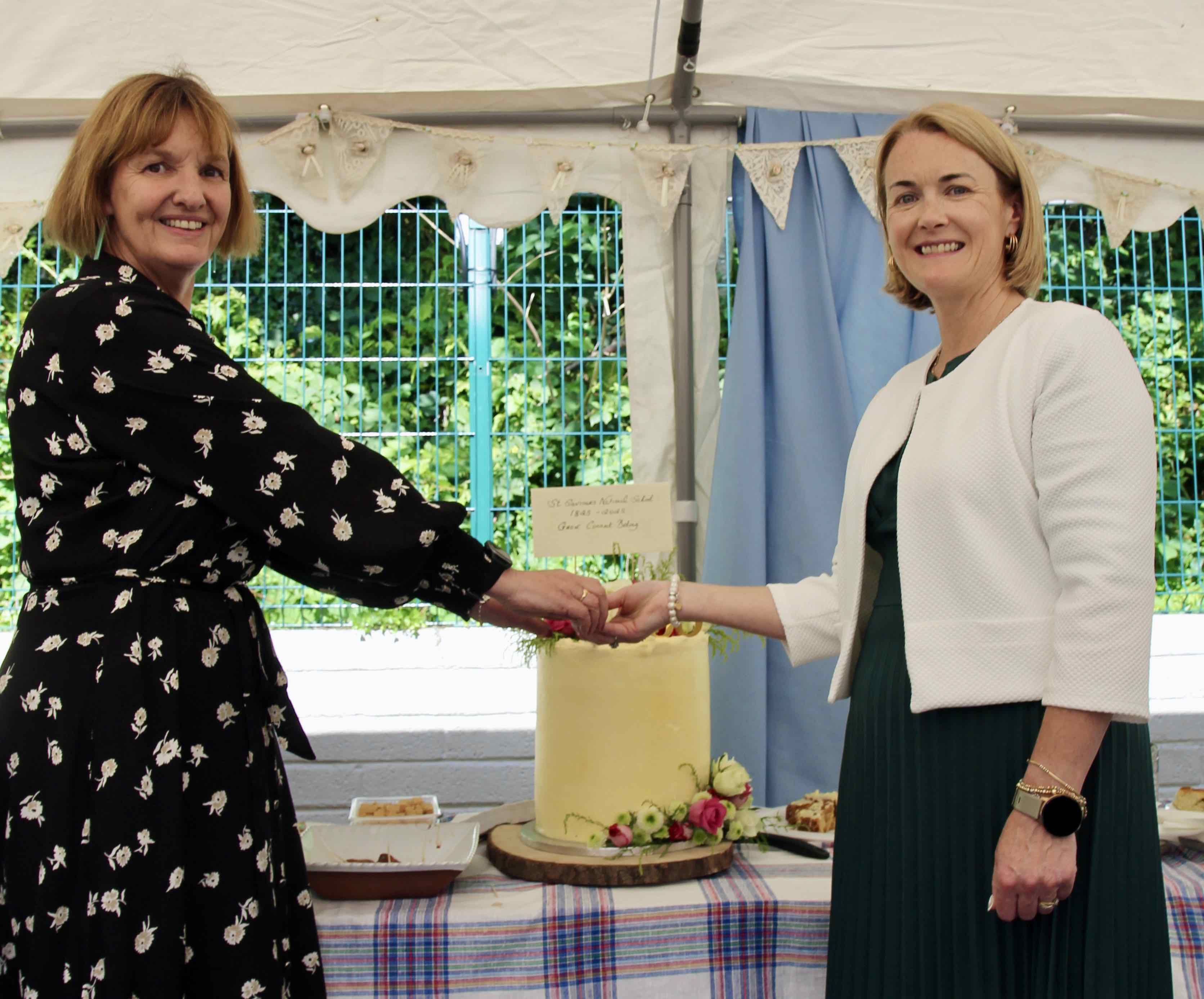 Antoinette Doyle and Victoria Spencer cut a very special cake.