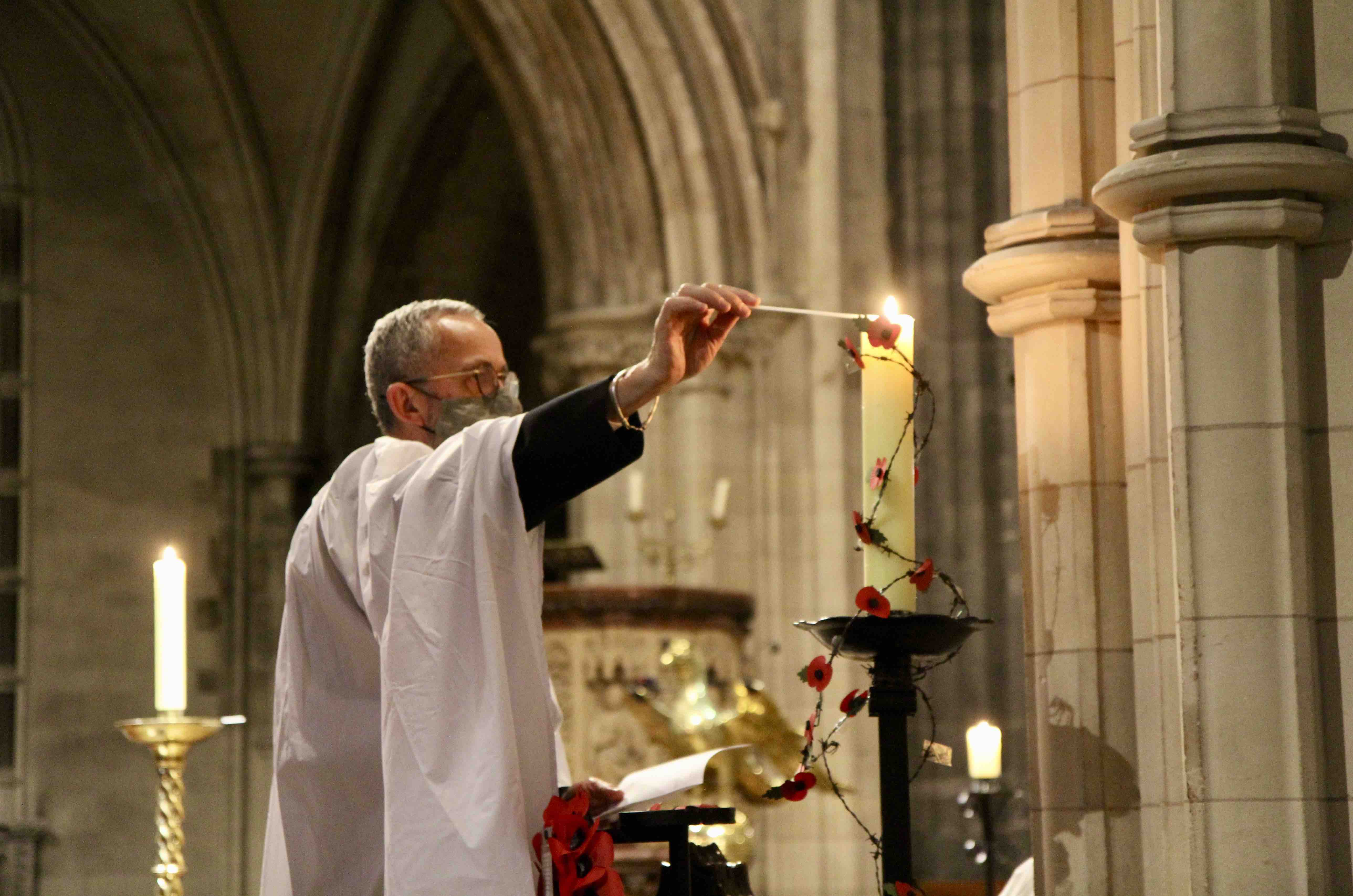 Dean  Dermot Dunne, lights a candle during the Service of Light.