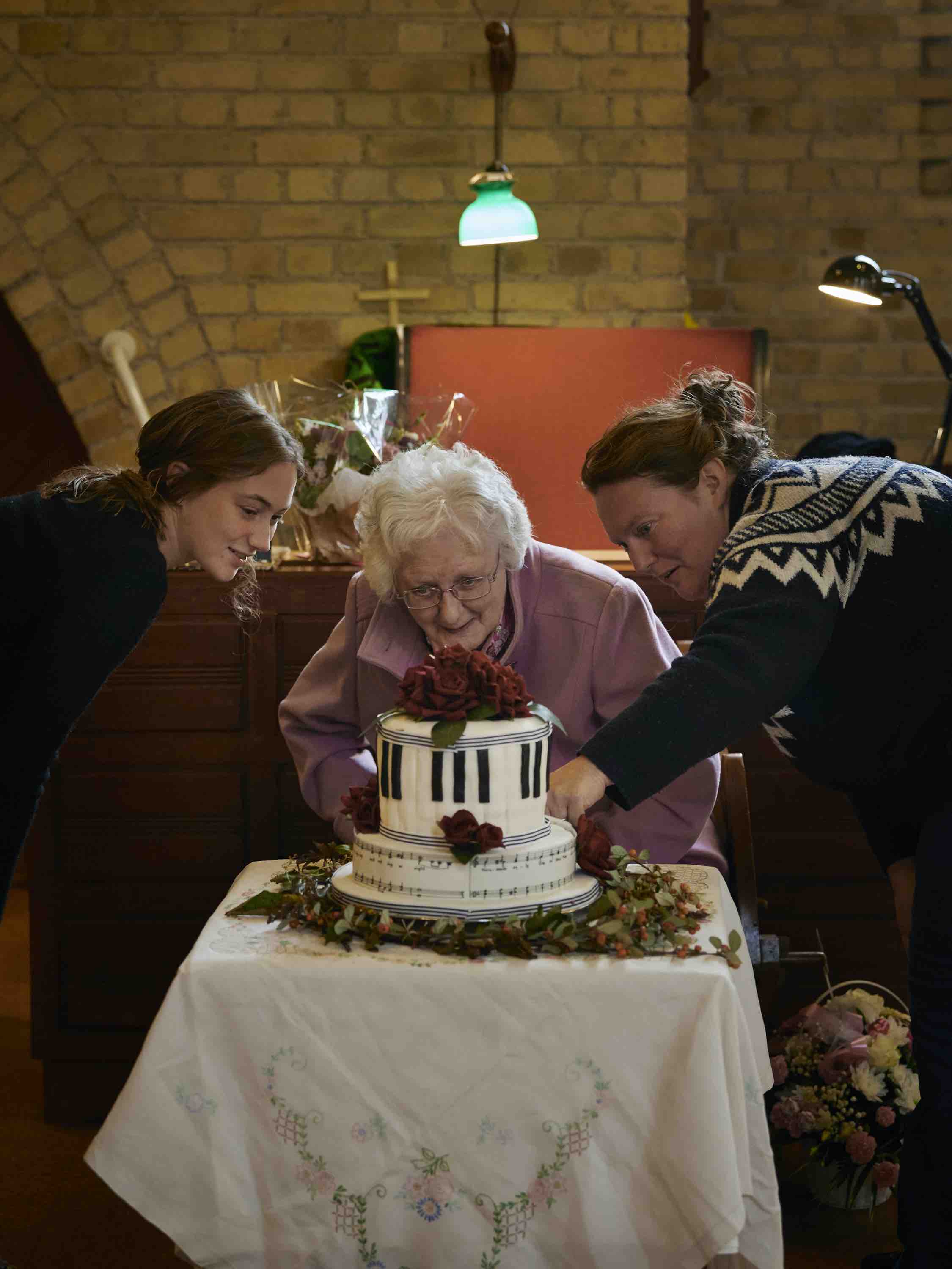 Joy with Daphne Deacon and Ava and the cake baked to mark the occasion.