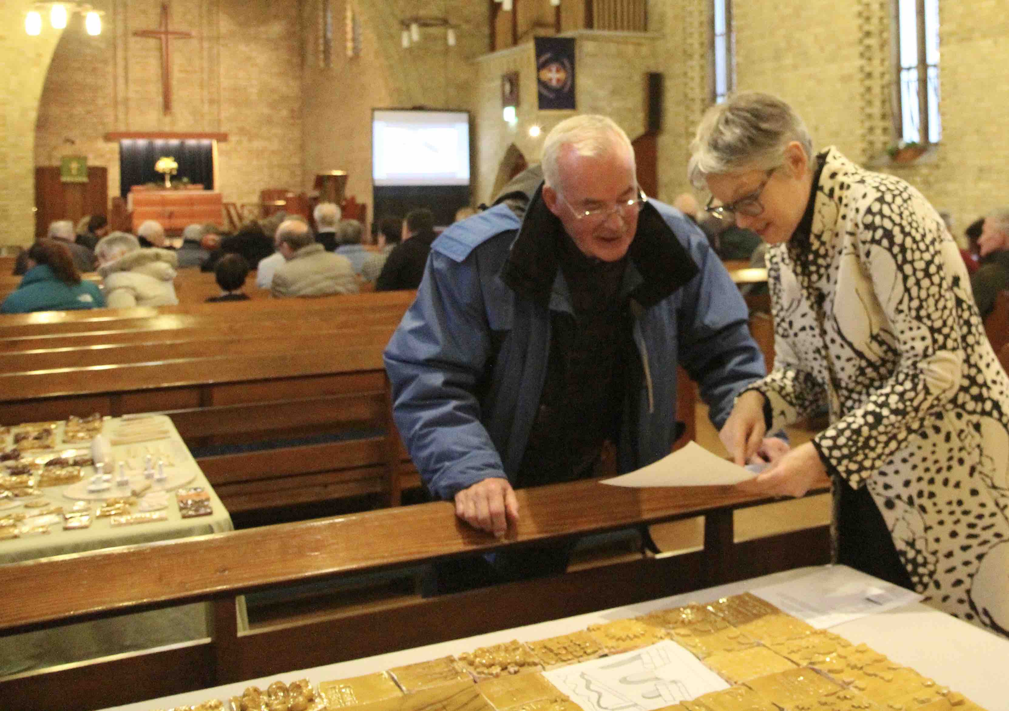 Parishioner Janice McAdam shows David Whyte, whose father Herbie was a Rector in Crumlin, the artistic process of the project.