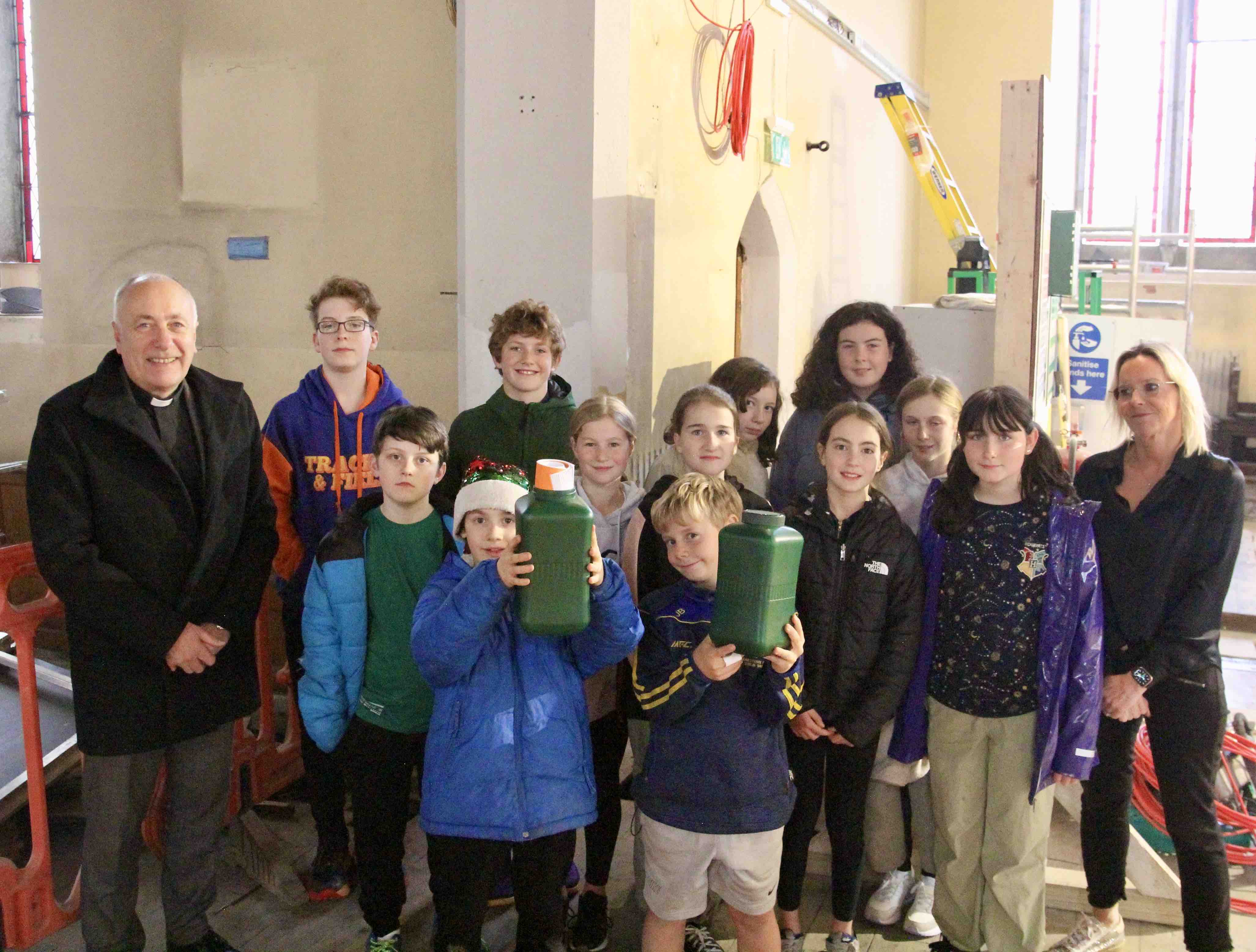 Representatives of Fifth and Sixth Classes of St Matthew's NS with their principal Cliodhna O'Reilly and Canon Leonard Ruddock.