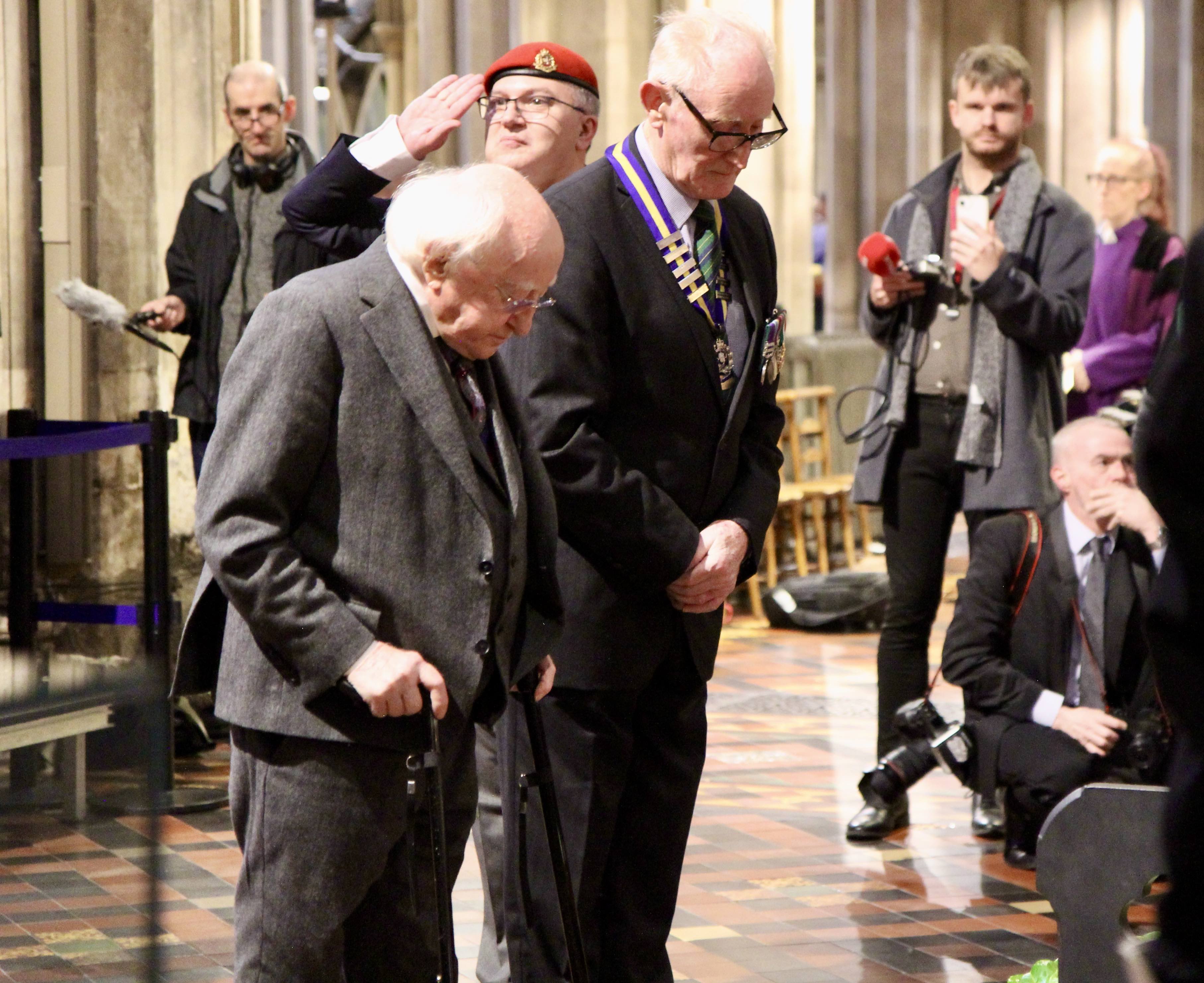 President Michael D Higgins and Lt Col Ken Martin stand before the wreaths they laid in the north transept.