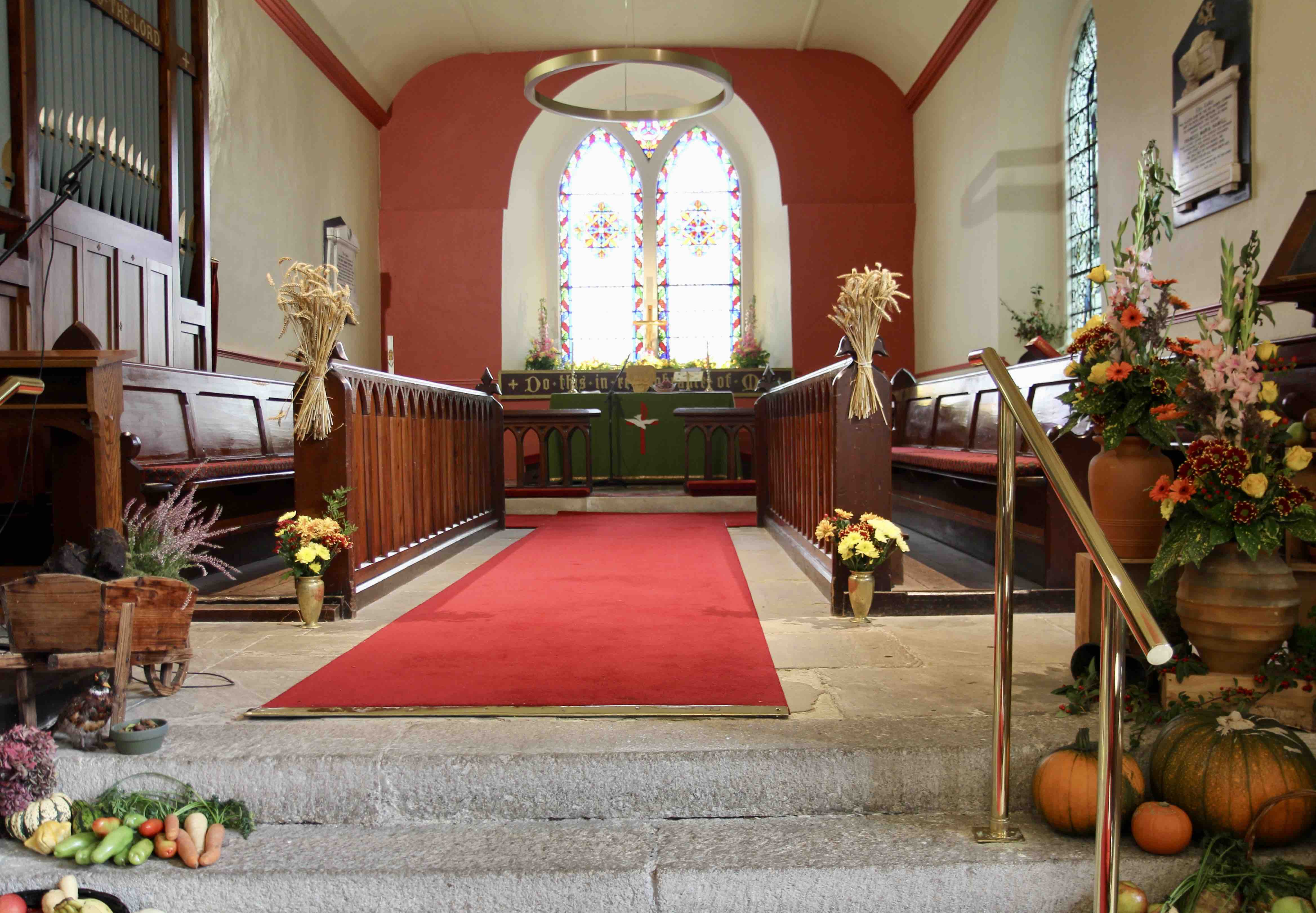 The chancel of St Mary's with new lighting and decorated for harvest.