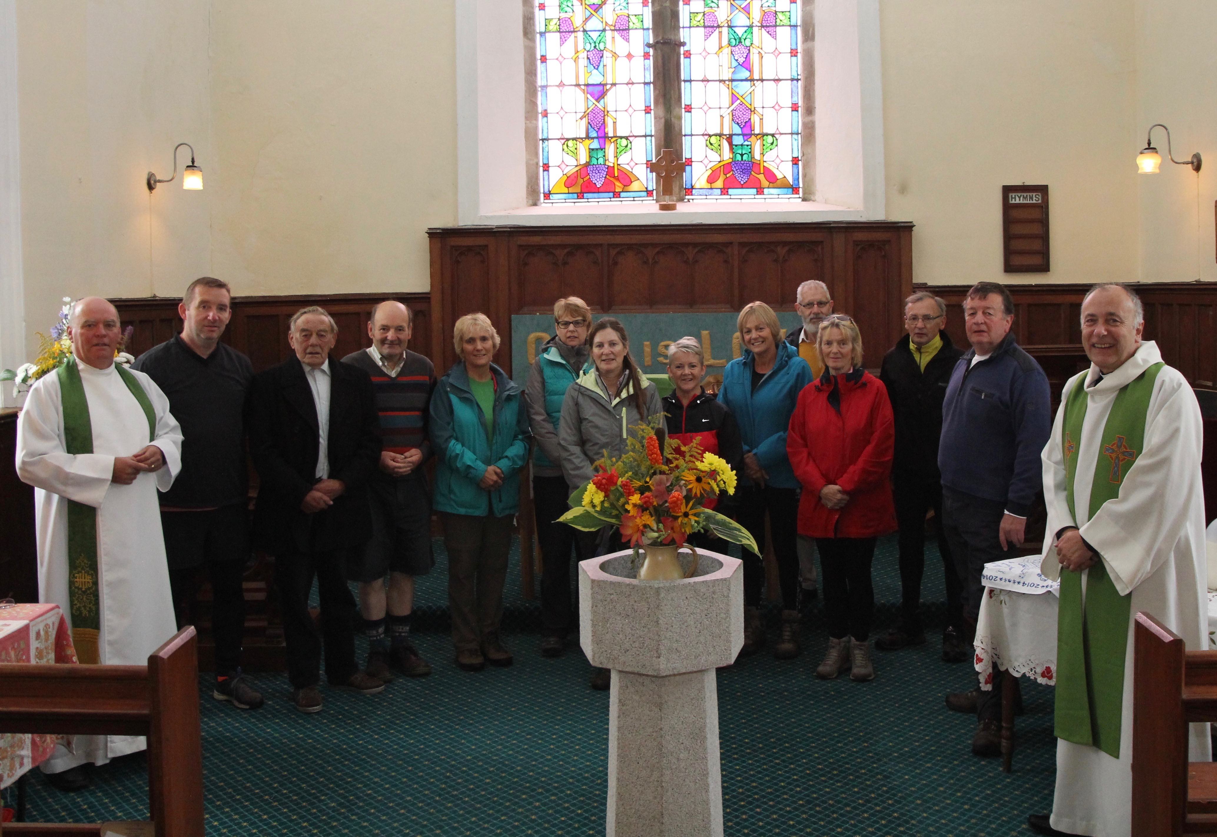 Participants in the Camino de Glendalough receiving their pilgrim blessing in St Kevin's Church, Hollywood