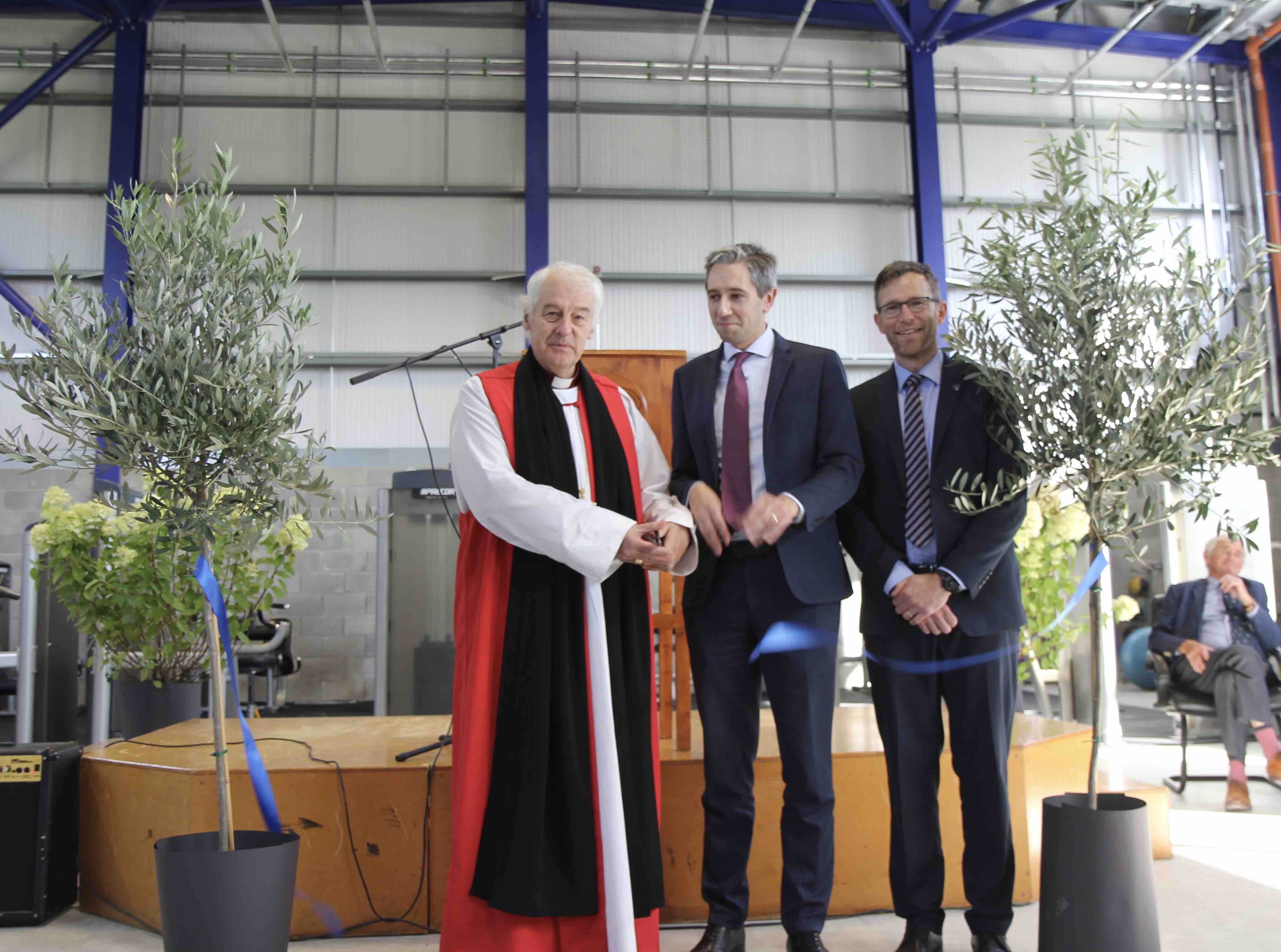 Archbishop Michael Jackson, Minister Simon Harris and principal Craig Petrie cut the ribbon for the new EGS sports hall.