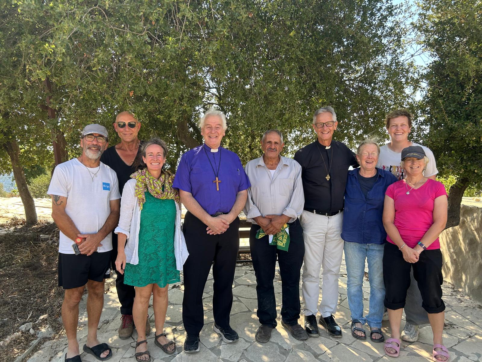 Archbishop Jackson with Emma Cowan Leite, a member of the Nassar family and others working at the Tend of Nations.
