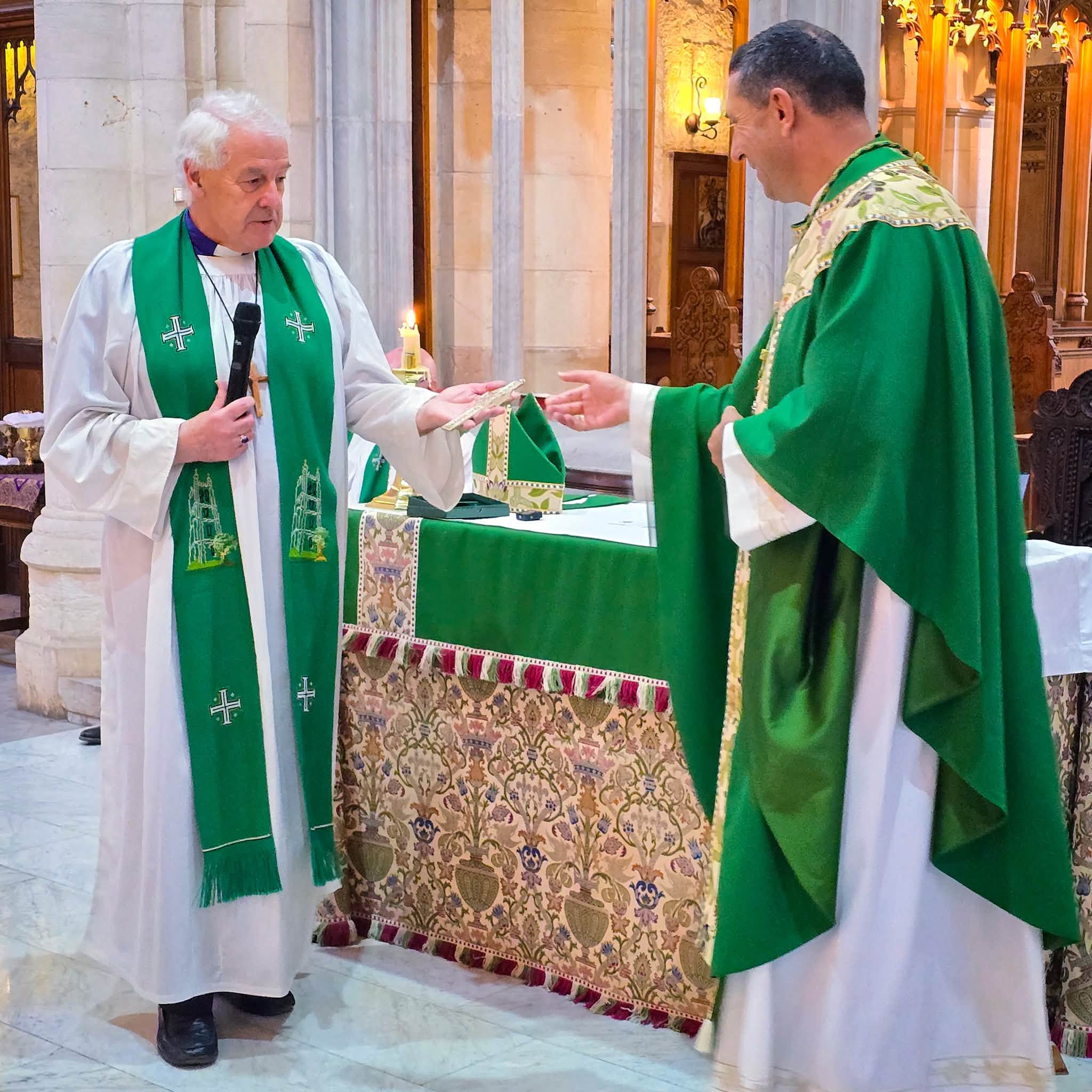 Archbishop Michael Jackson presents a Celtic Cross to Archbishop Hosam Naoum.