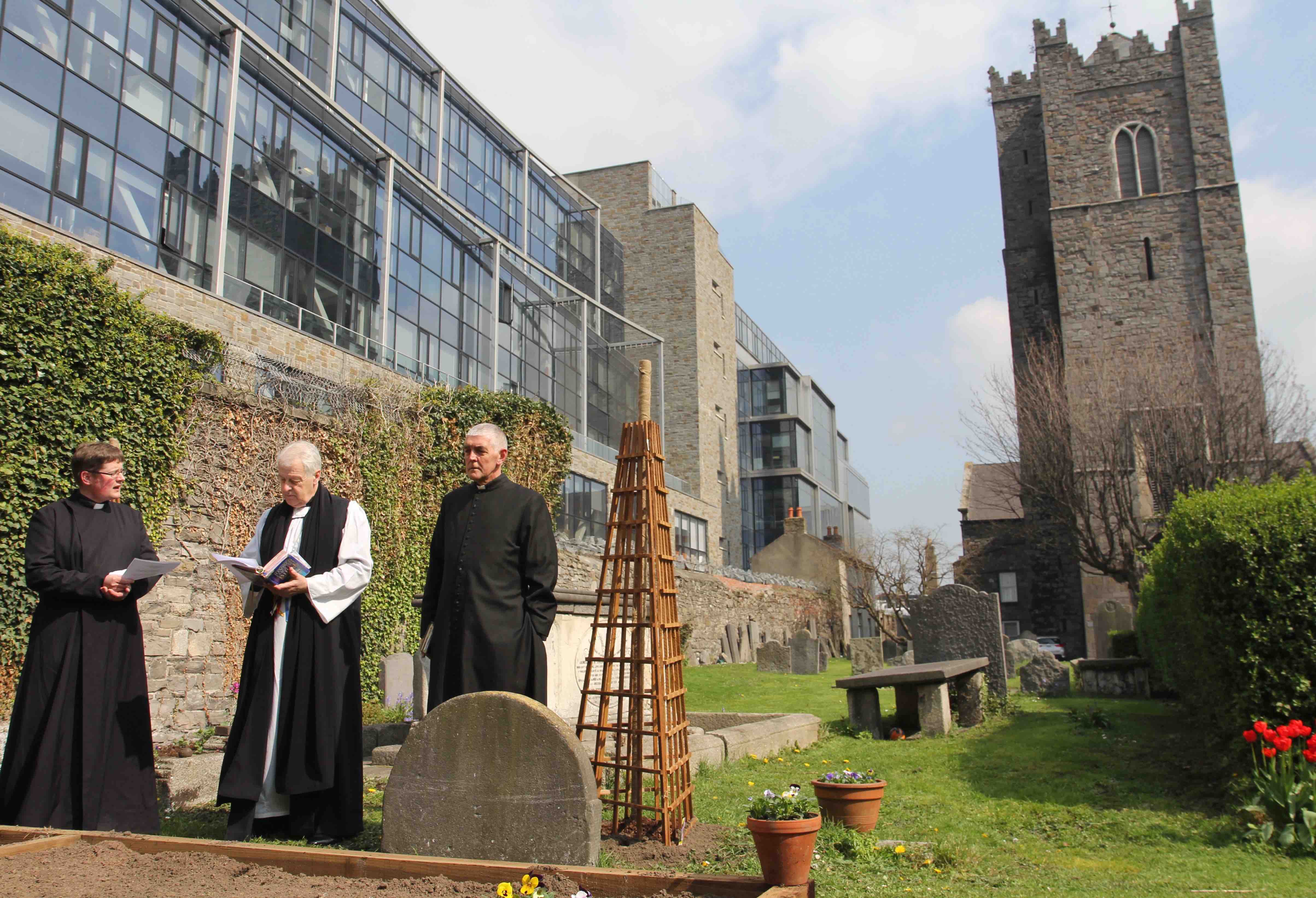 Archbishop Michael Jackson dedicates St Michan's community garden with Archdeacon David Pierpoint and the Revd Ross Styles.