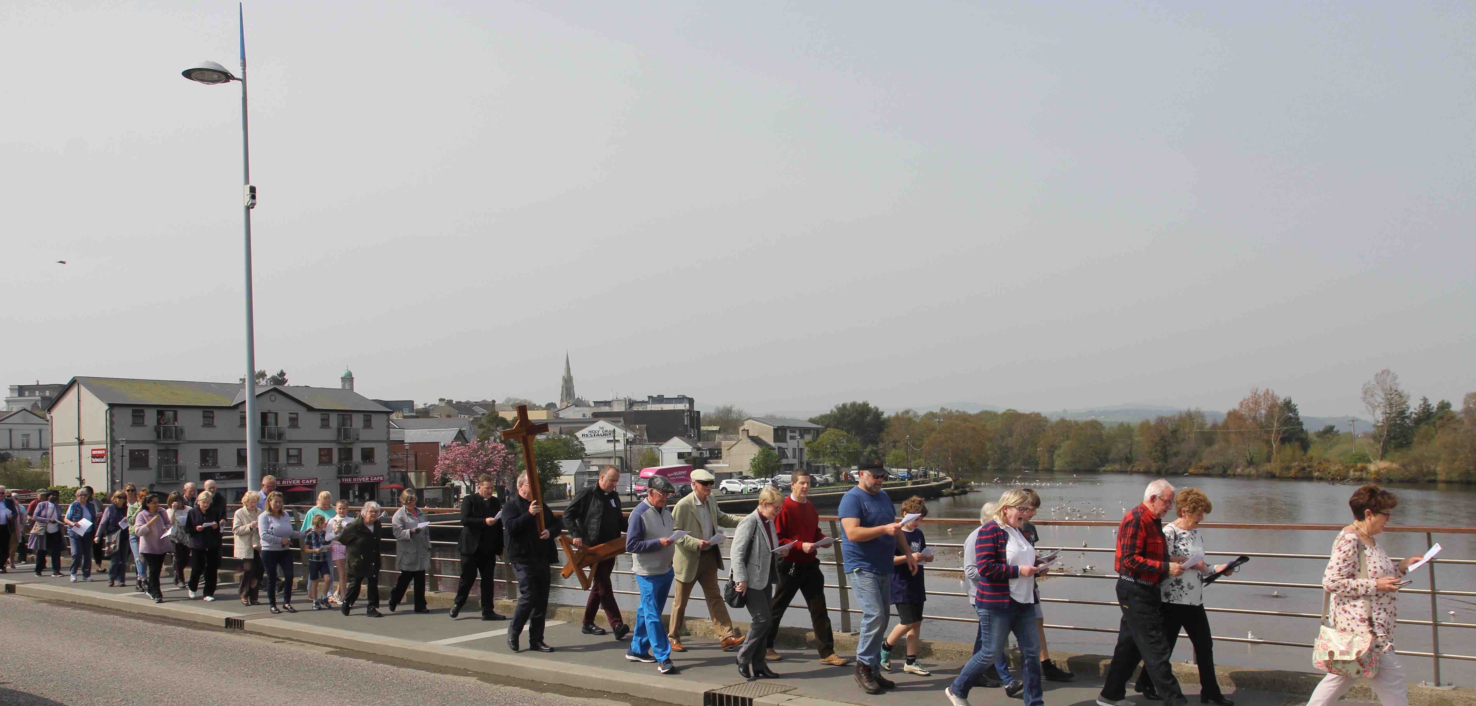 Participants in the Way of the Cross in Arklow cross the Avoca River.