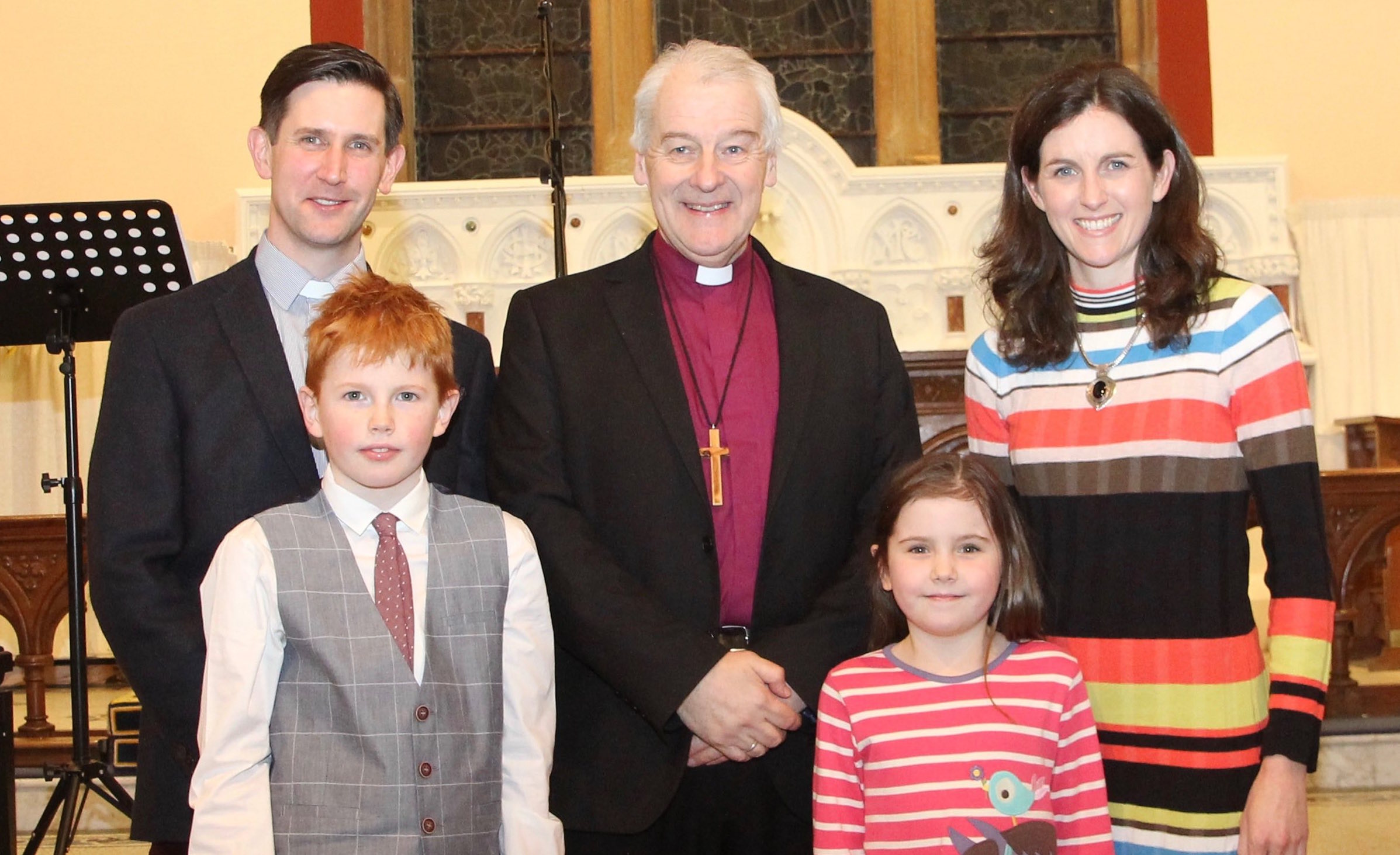 The Revd David Martin, his wife Honour and two of their children with Archbishop Michael Jackson.