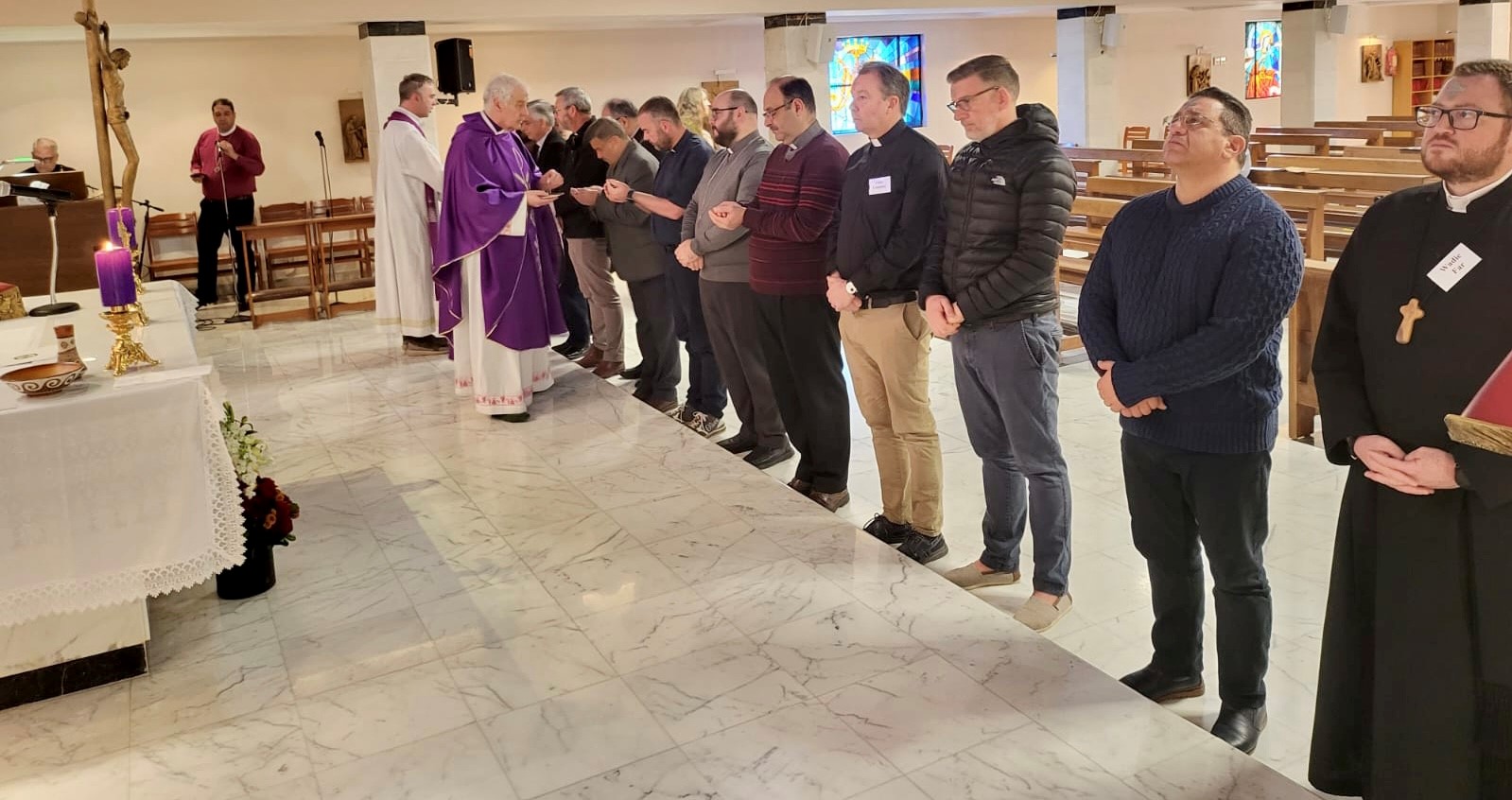 Clergy gathered around the Holy Communion Table.