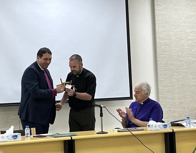 The Revd Colin McConaghie presenting Archbishop Naoum with a St Brigid's Cross.